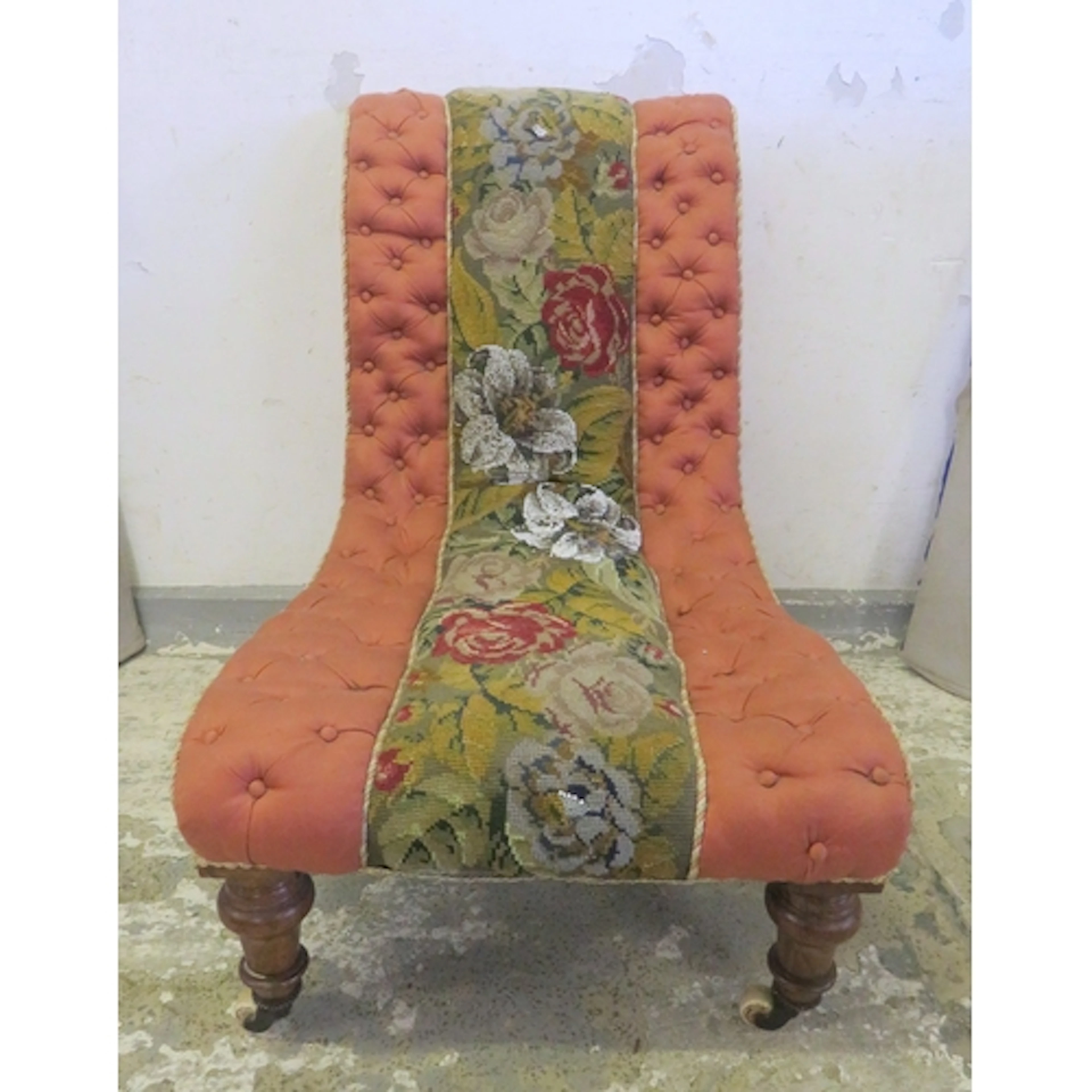 Antique Nursing Chair with pink buttoned upholstery on porce...