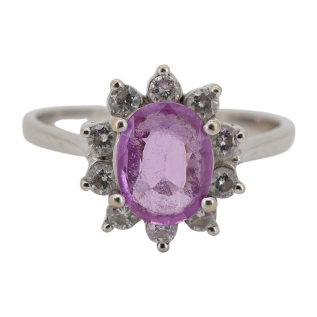 An 18k white metal, pink sapphire and diamond set oval clust...