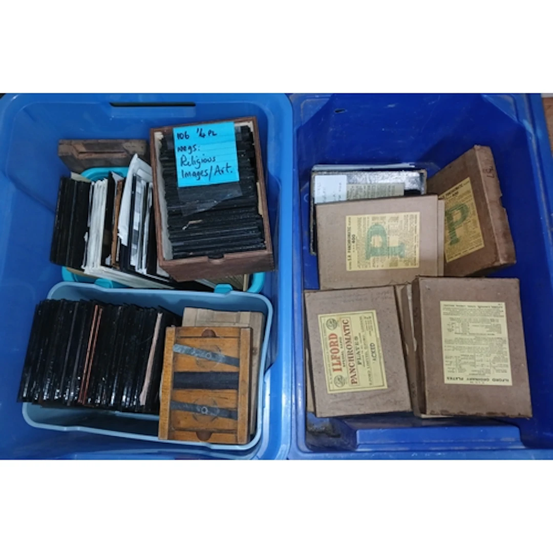 Two boxes of assorted glass plates.