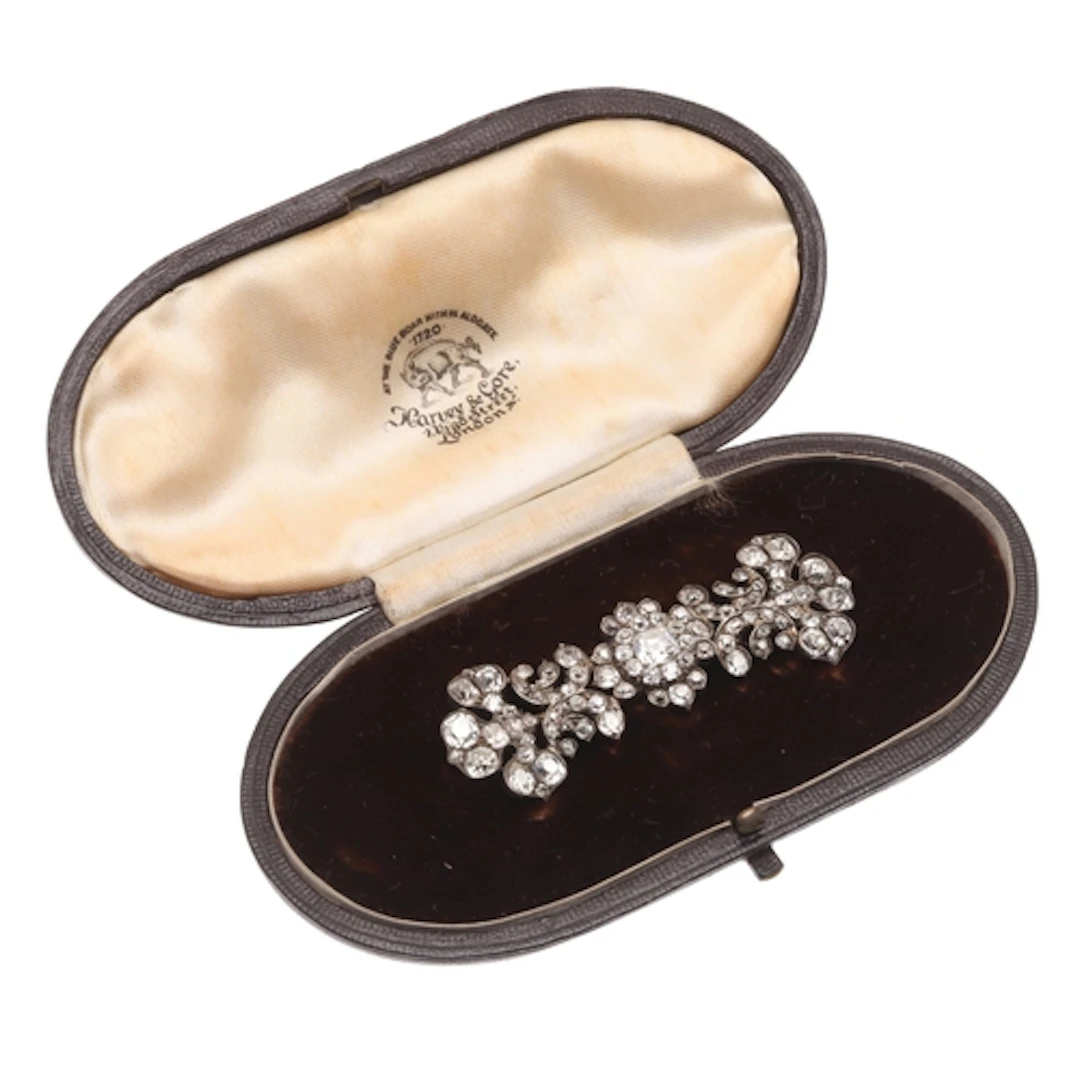 A VICTORIAN DIAMOND BROOCH. of foliate and scrolling form, t...