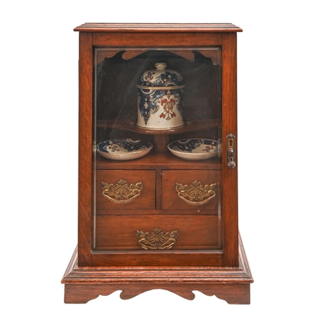 A late Victorian oak smokers cabinet, enclosed by bevelled g...