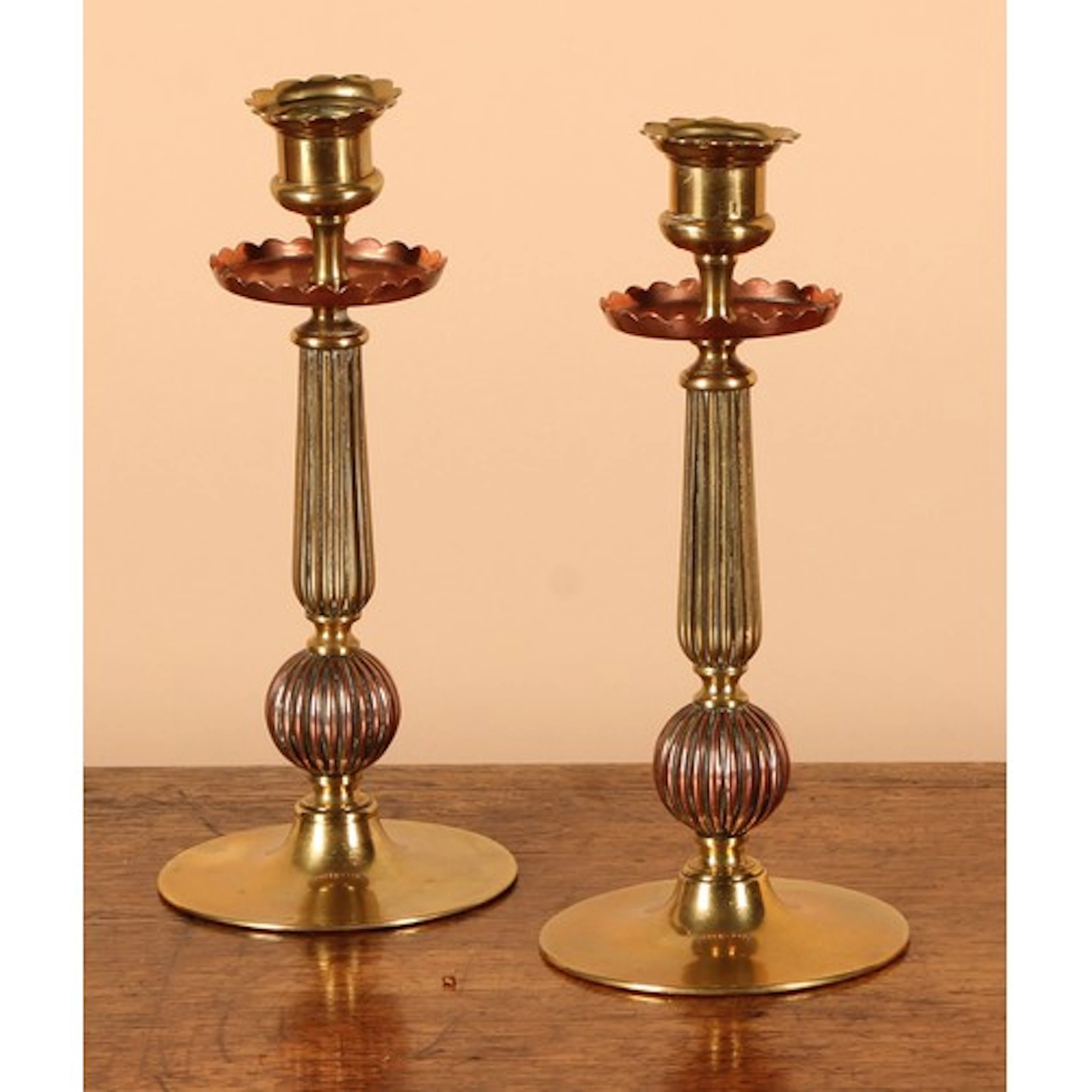 A pair of Arts & Crafts brass and copper candlesticks, 21.5c...