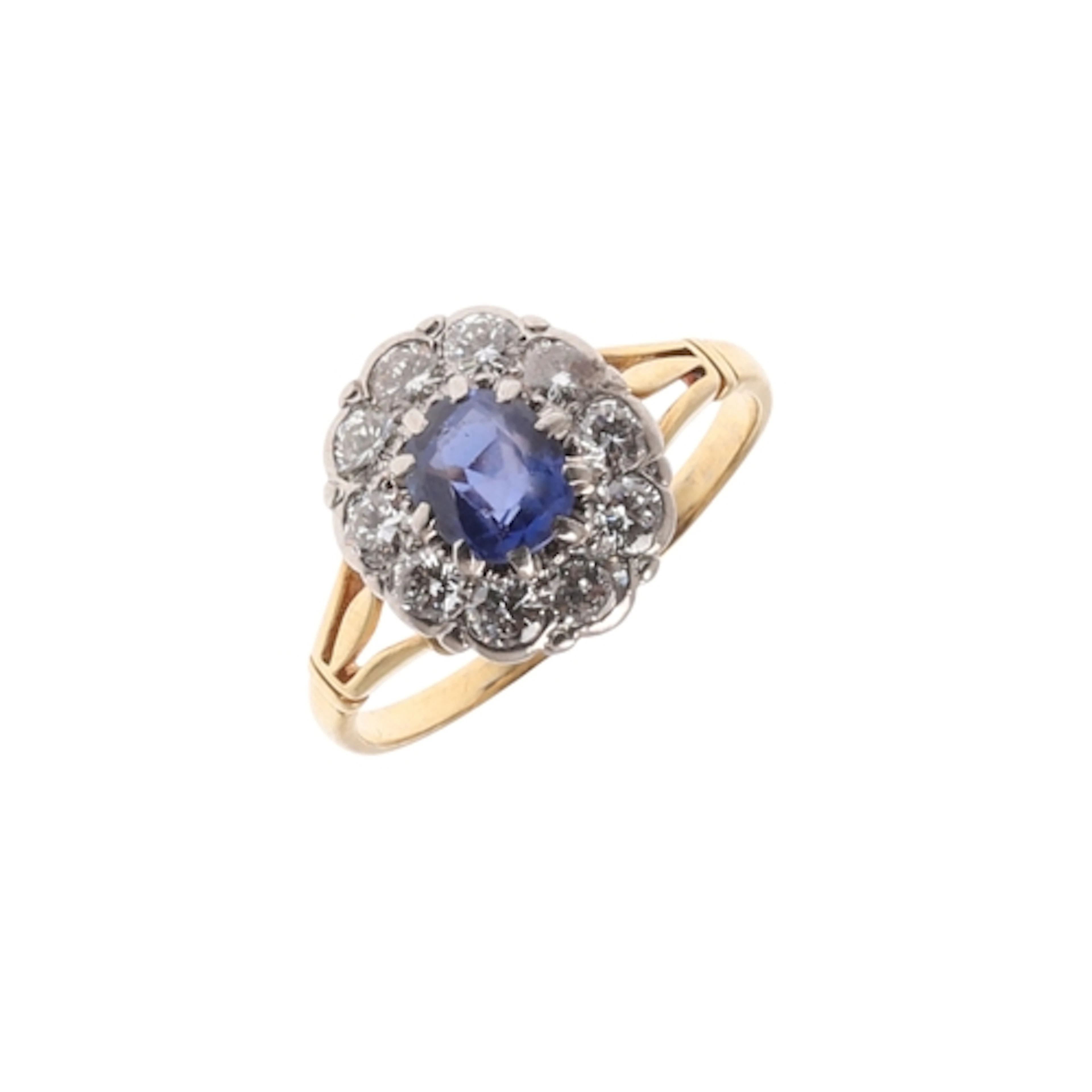 A SAPPHIRE AND DIAMOND CLUSTER RING. the oval-shaped sapphir...