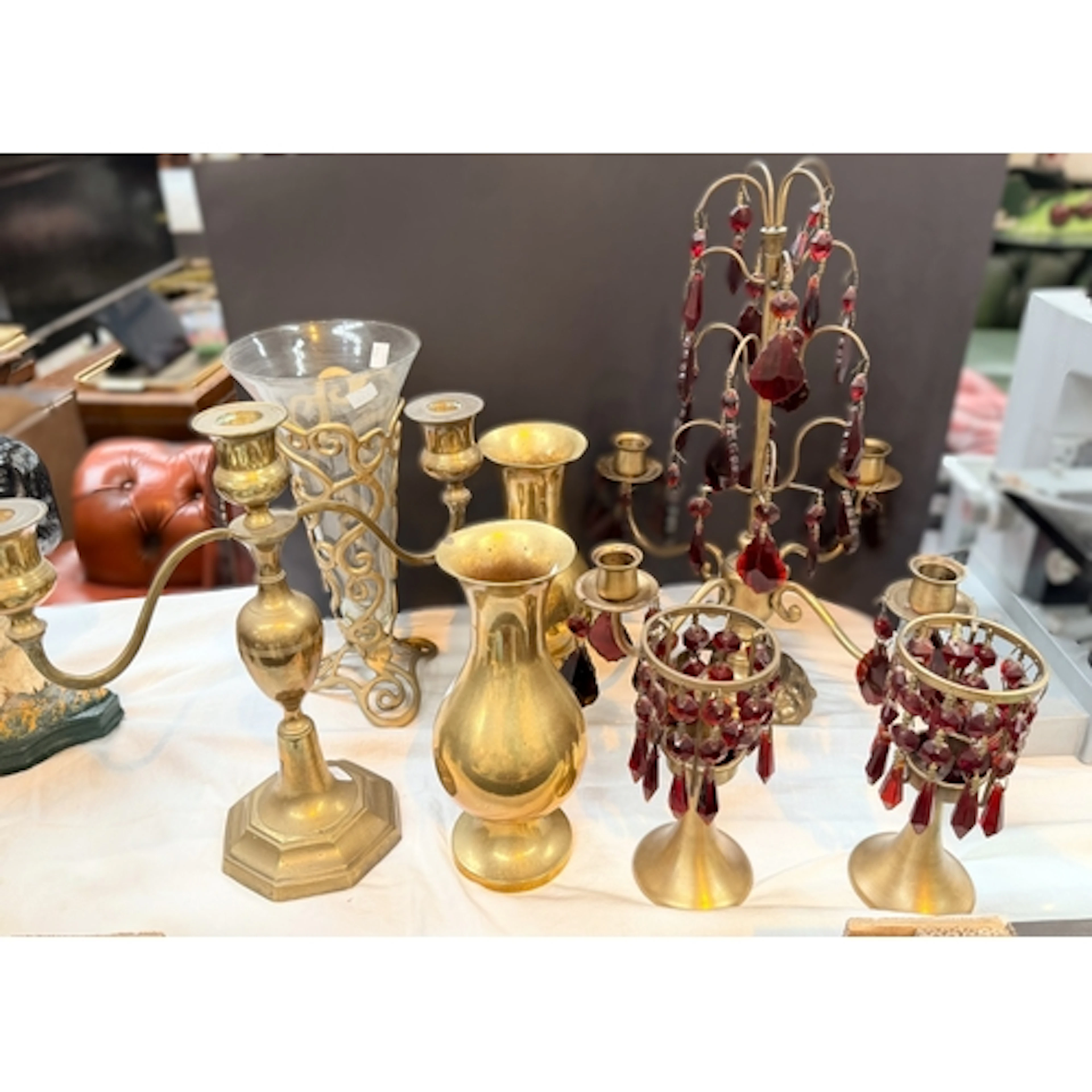 A brass four-branch table candelabra with ruby glass lustres...