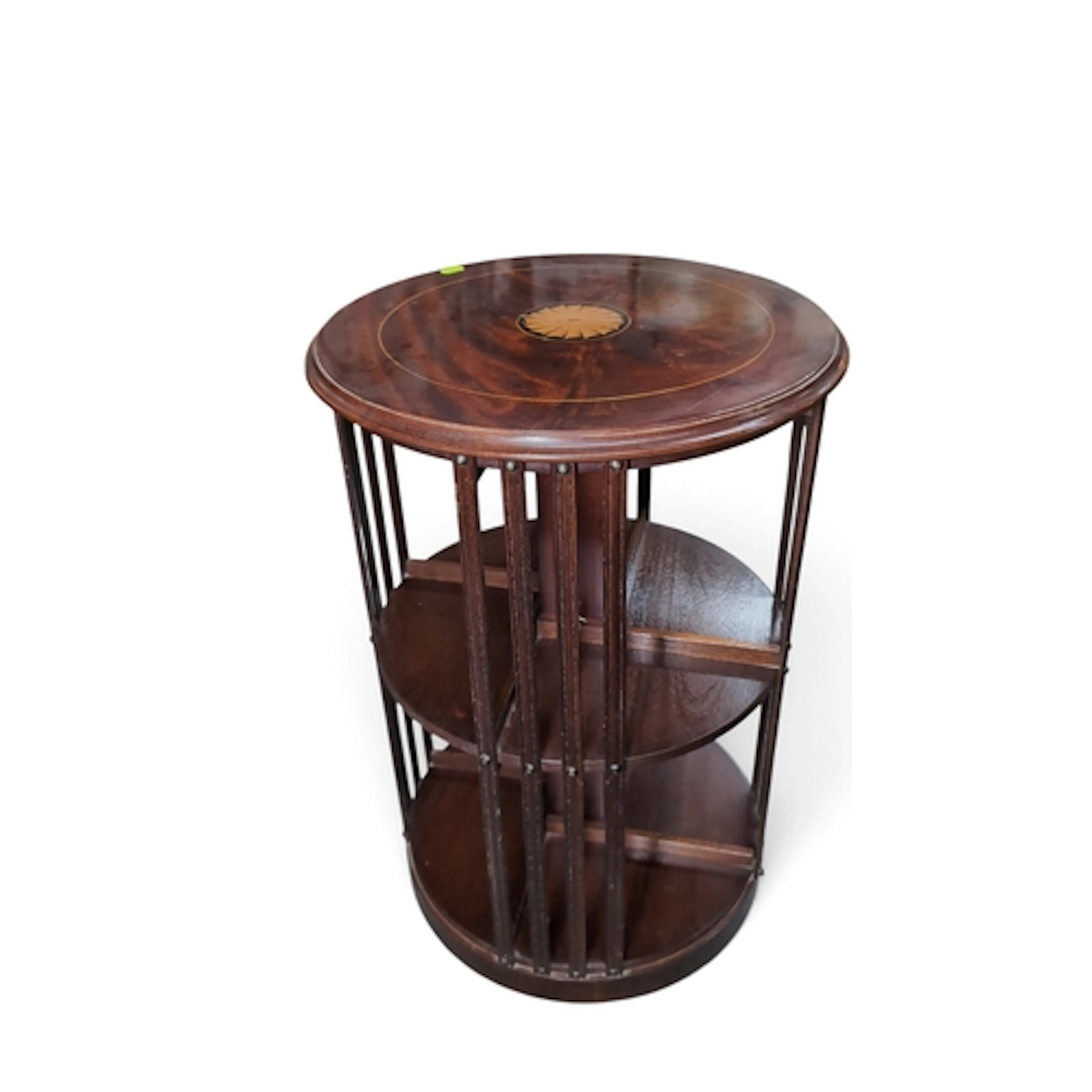 Mahogany revolving bookcase of circular form, the top inlaid...