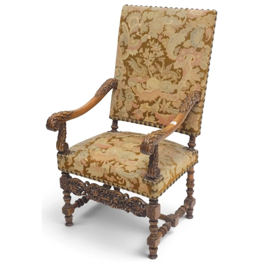 A 19th century walnut framed armchair with floral upholstere...
