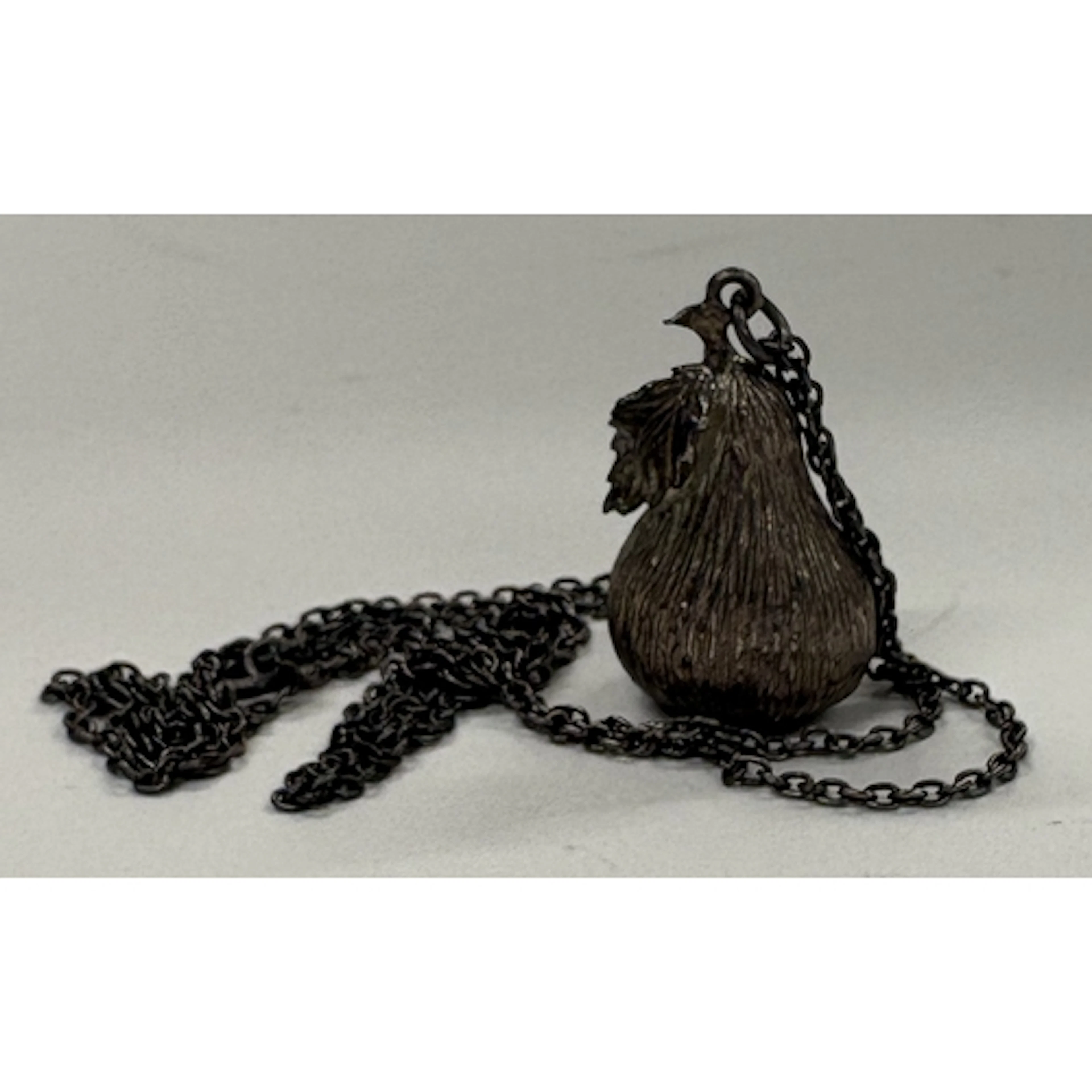 A rare silver necklace with cast pear pendant. London 1977. ...