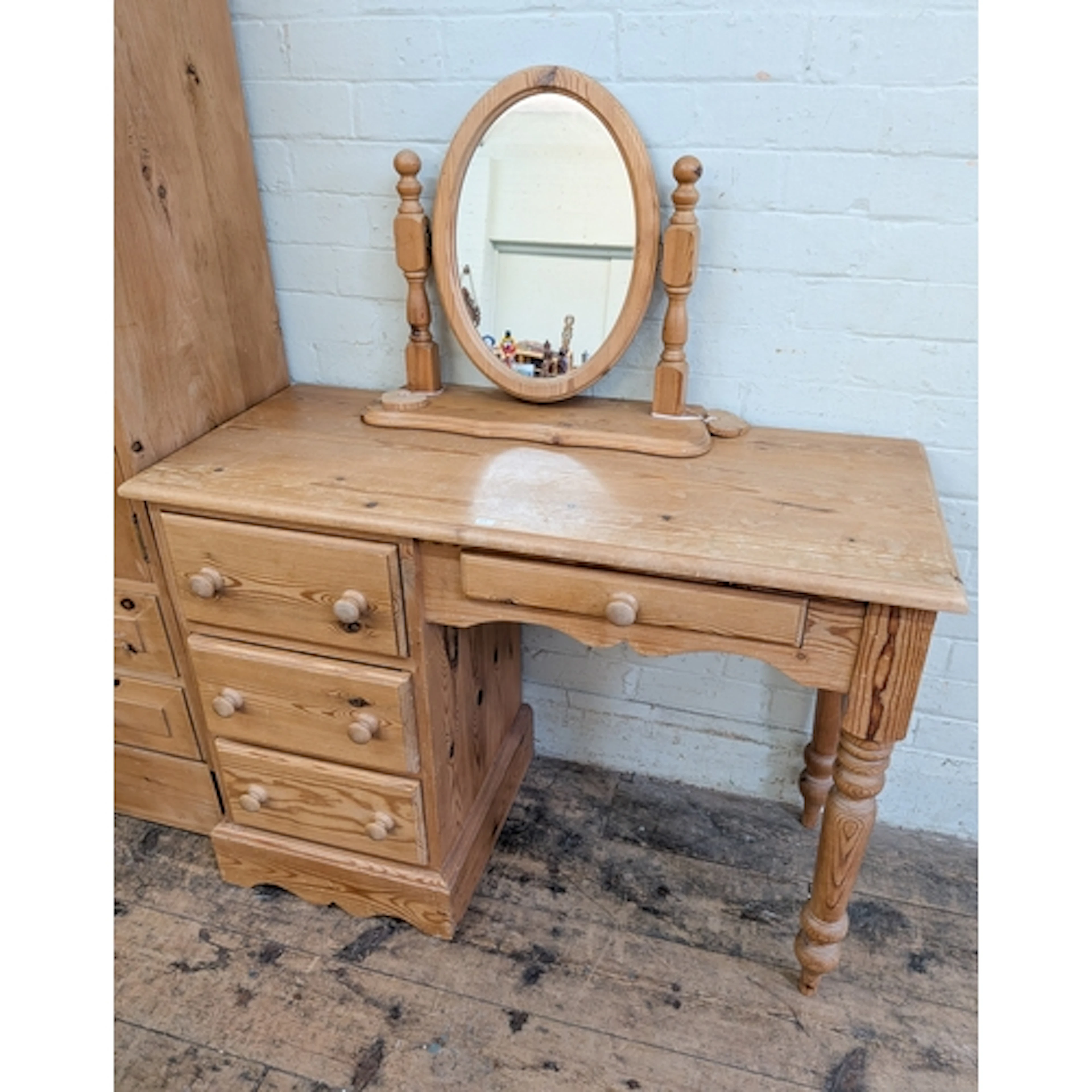 A stripped pine single pedestal dressing table fitted four d...