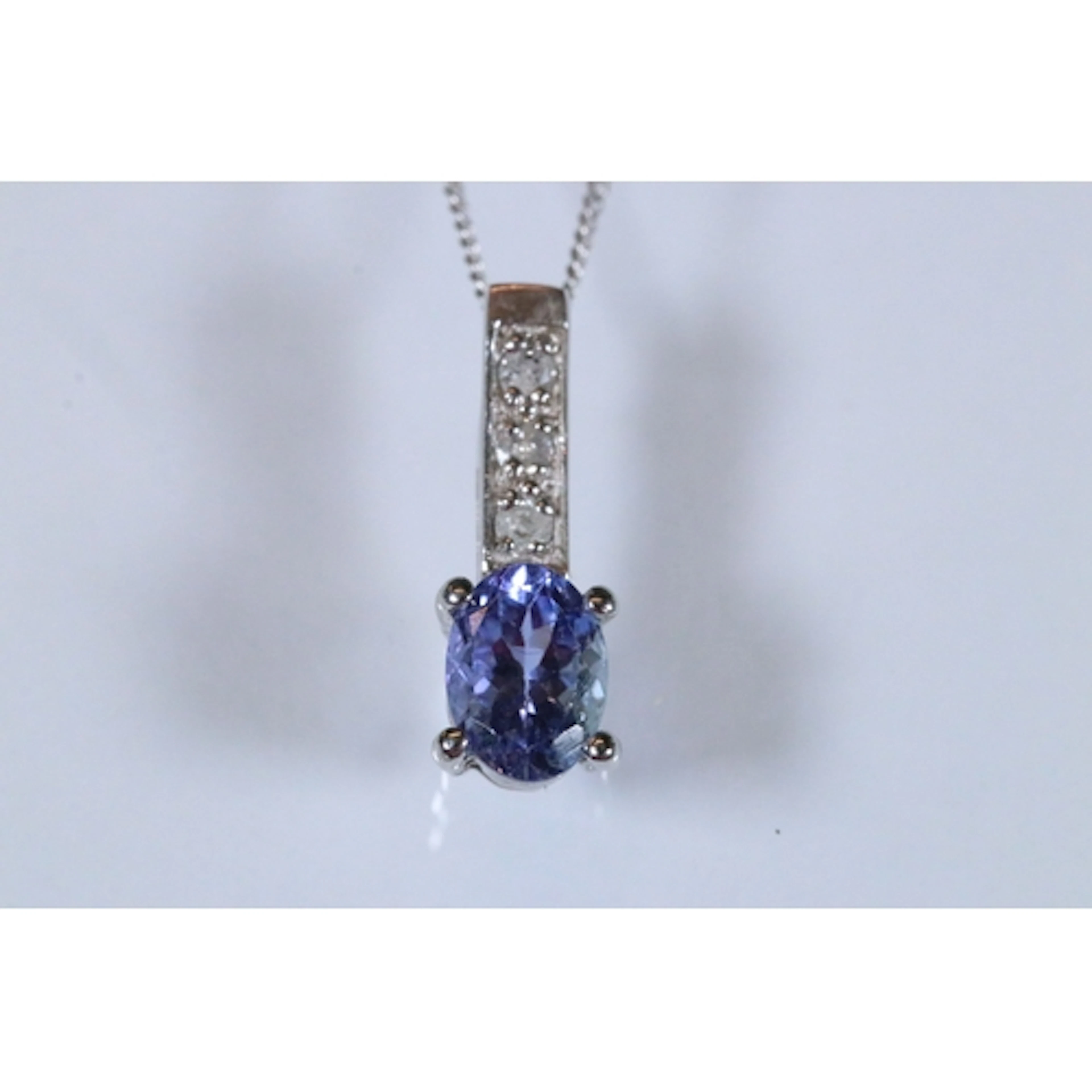 9ct white gold iolite and diamond pendant necklace. The neck...