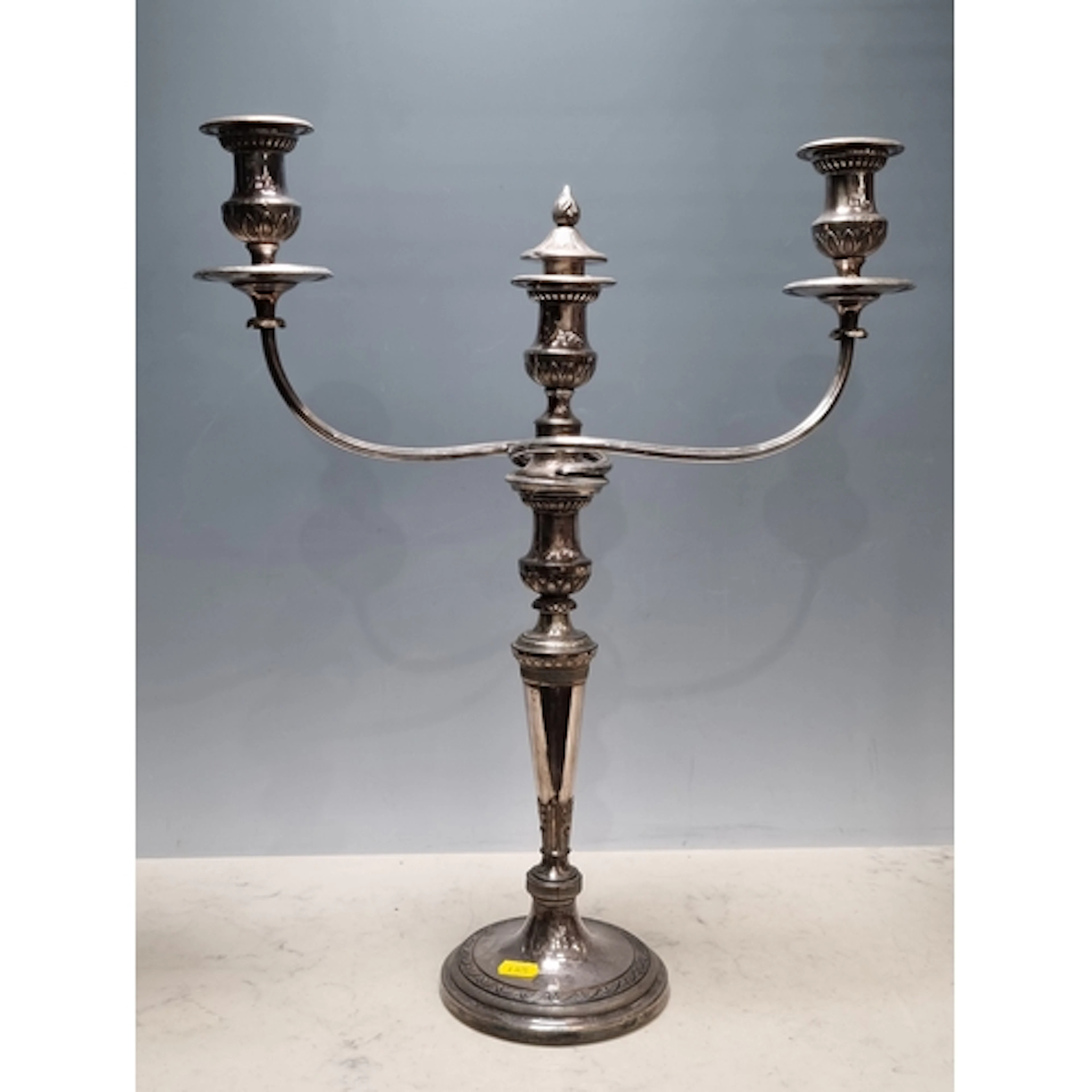 A silver plated two branch Candelabra with tapering column a...