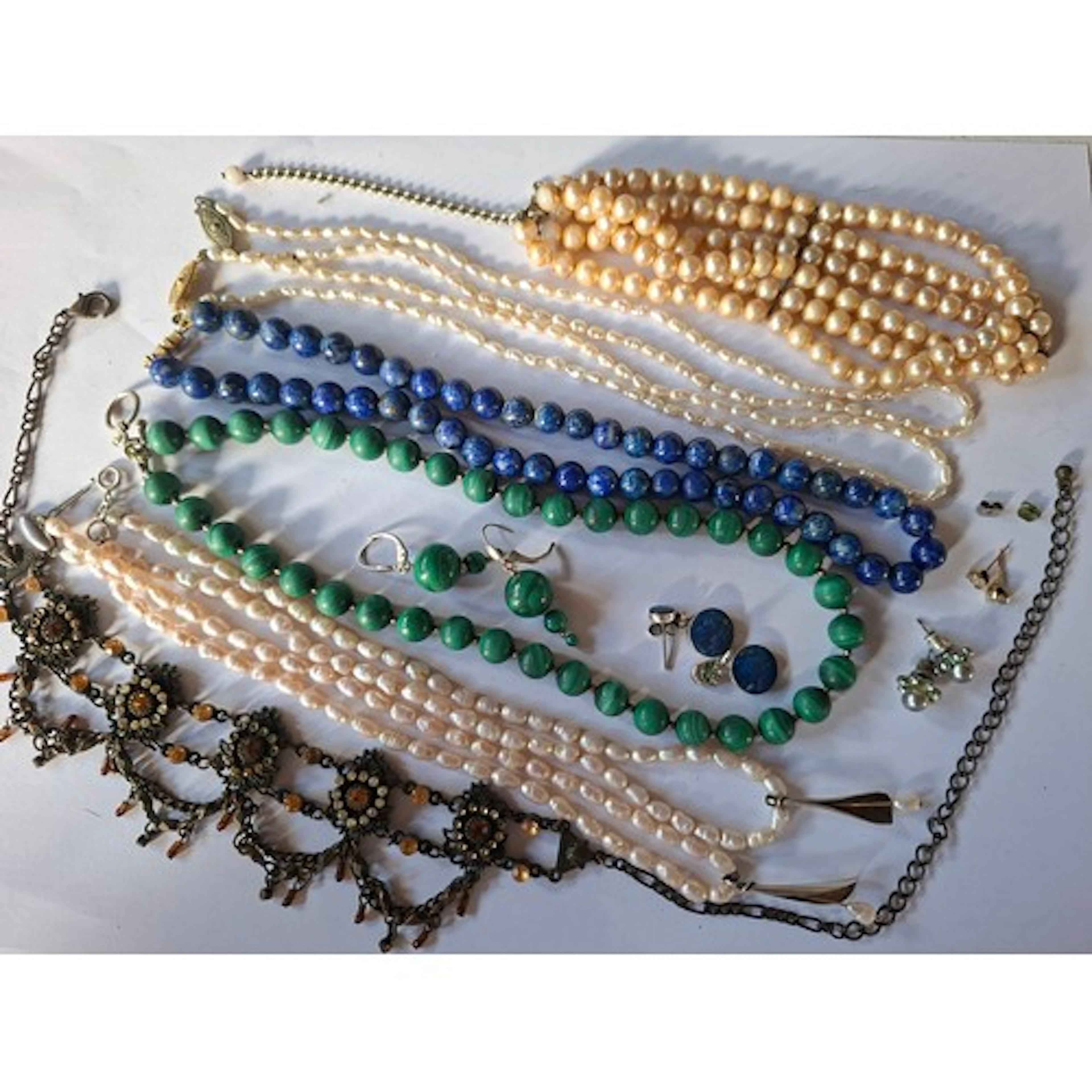 A quantity of costume jewellery comprising a pair of 9ct gol...