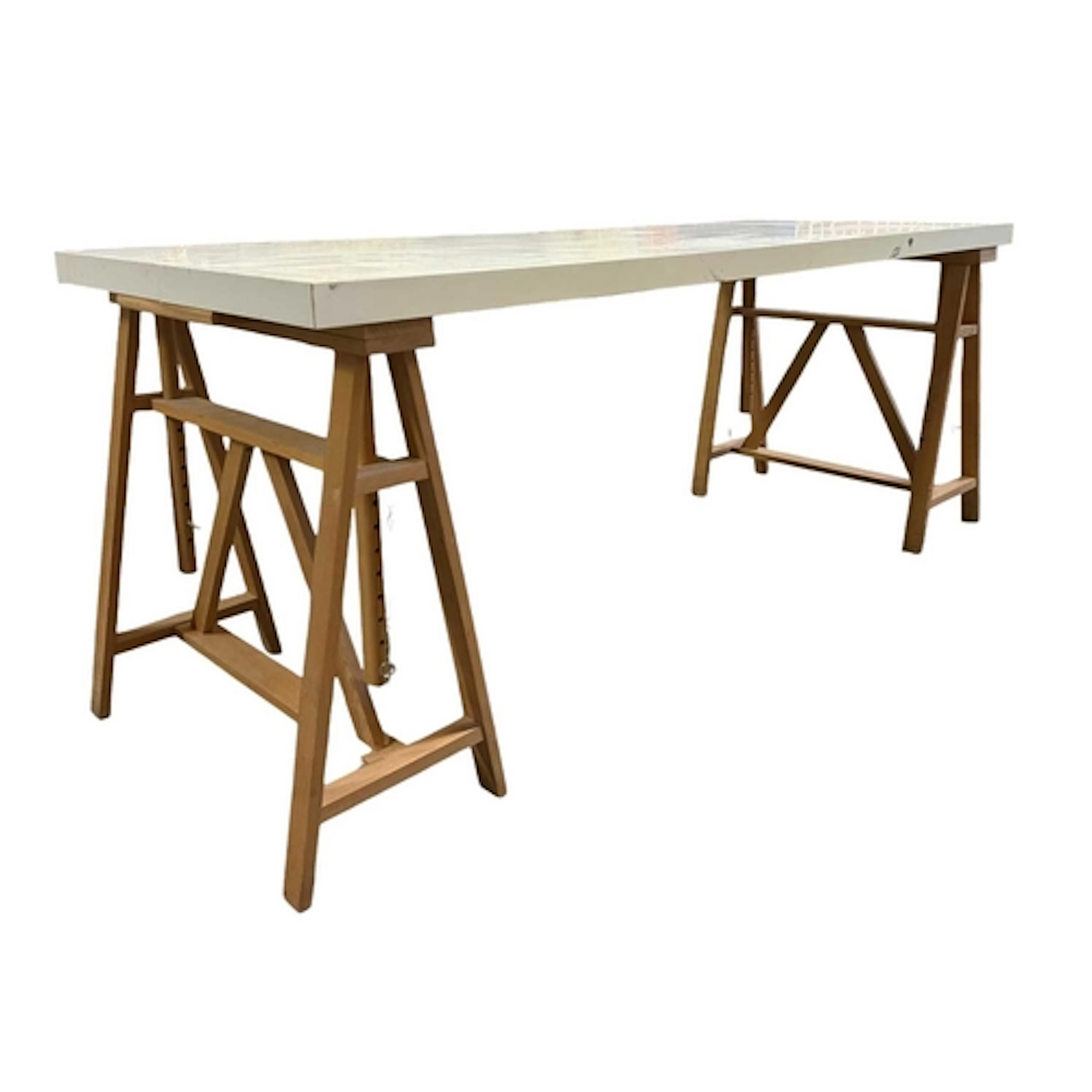 A modern white-topped trestle desk / work table. The table h...