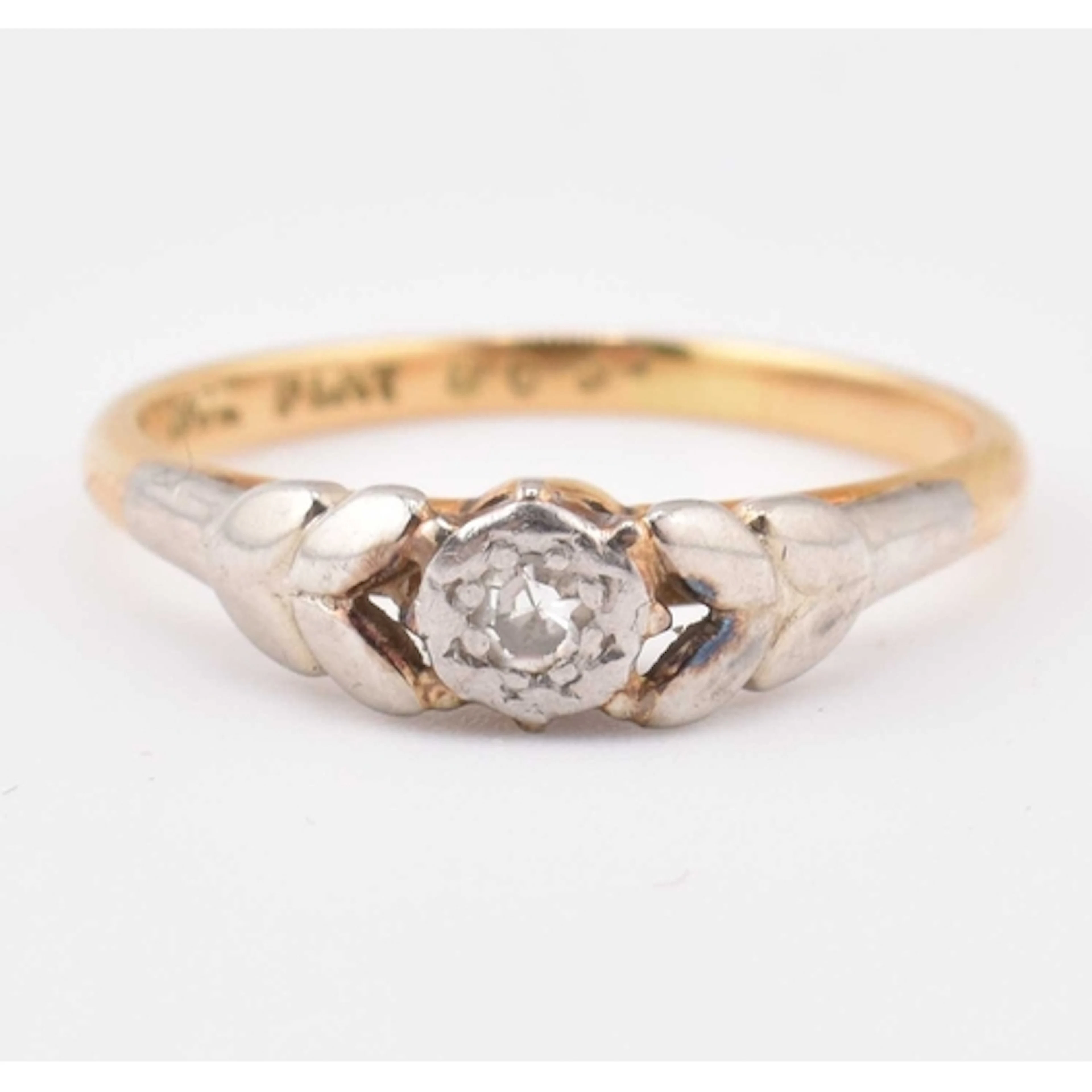 An 18ct gold and platinum diamond single stone ring. Stamped...