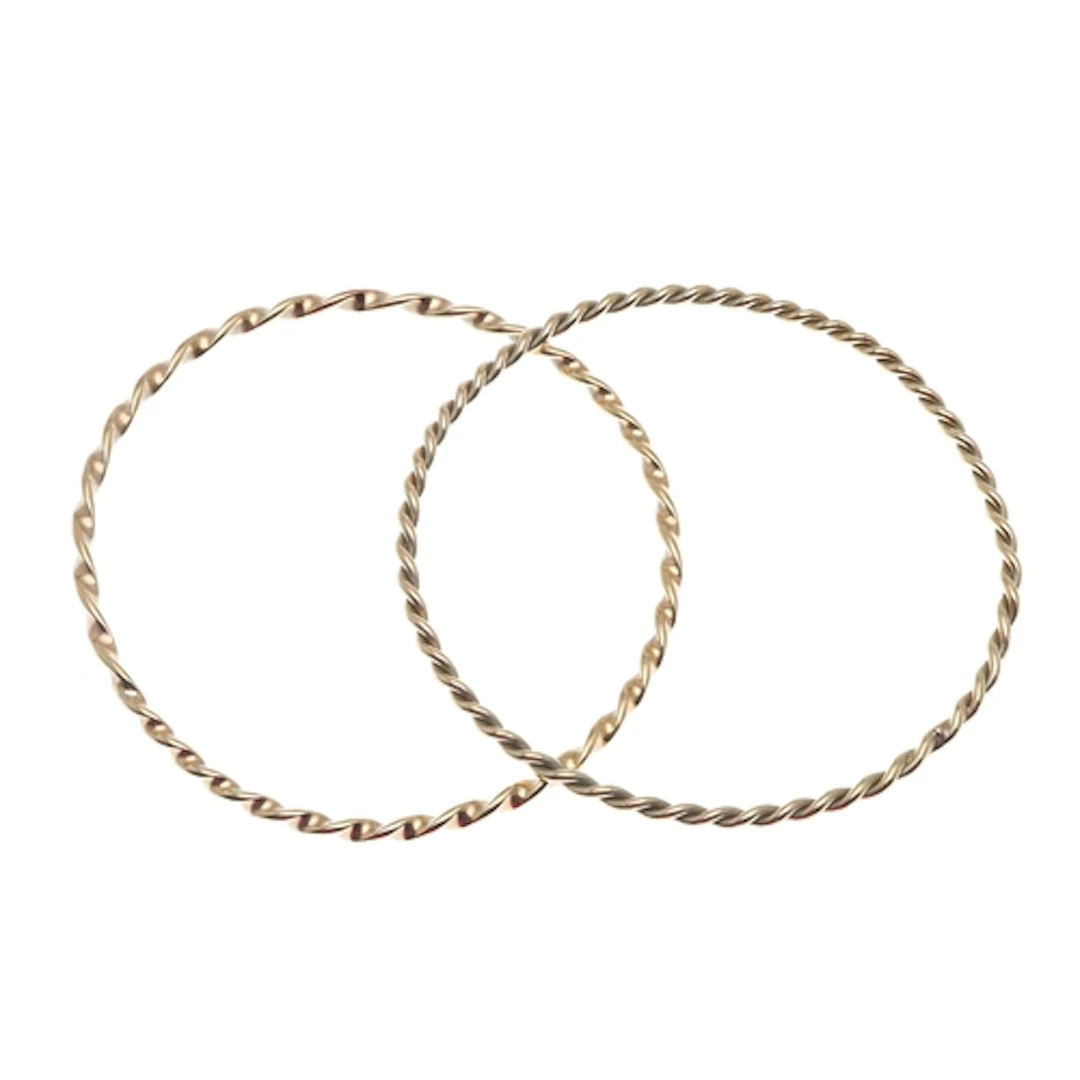 TWO GOLD BANGLES. each of similar twist design, internal mea...