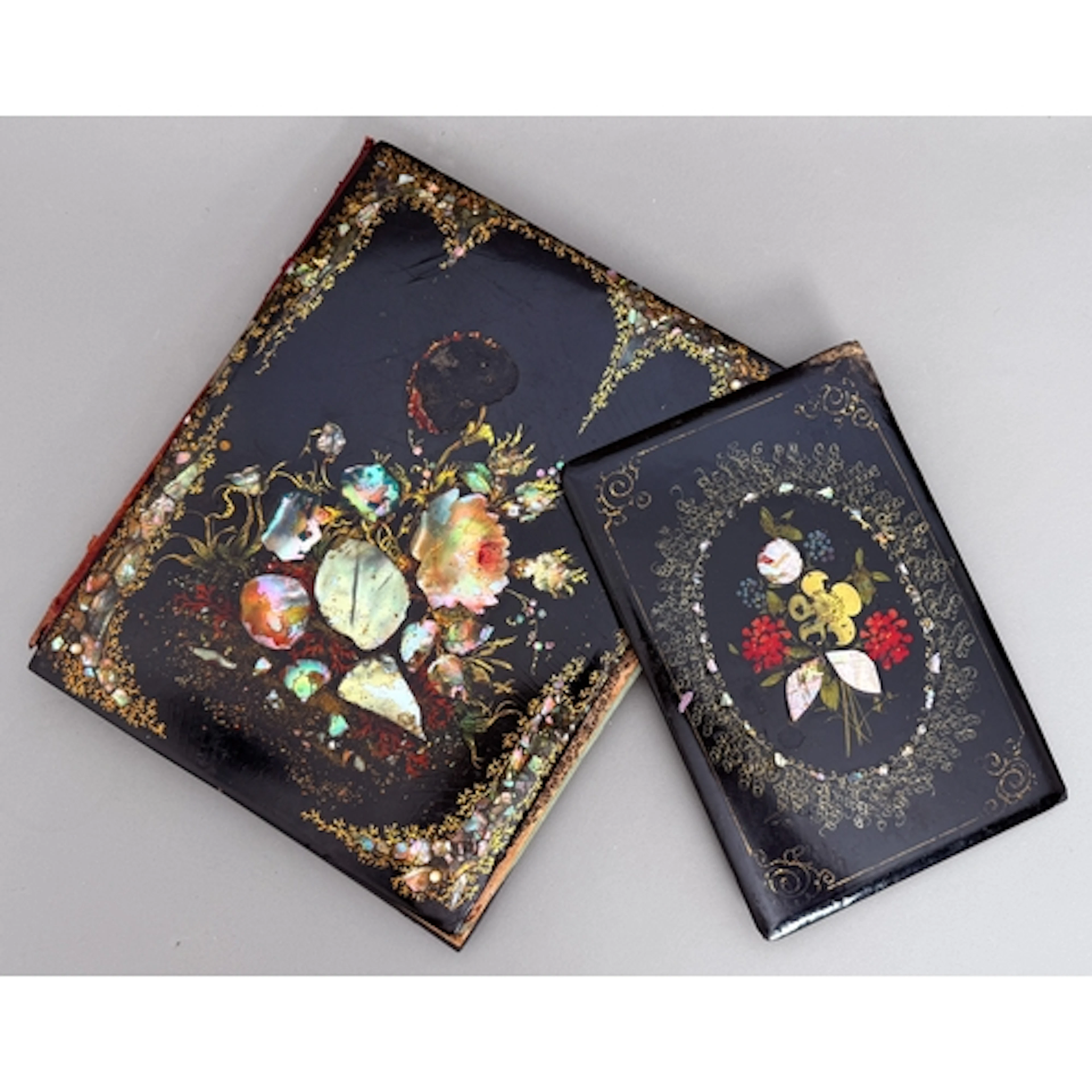 Two Victorian black laquer book covers - with floral motifs,...