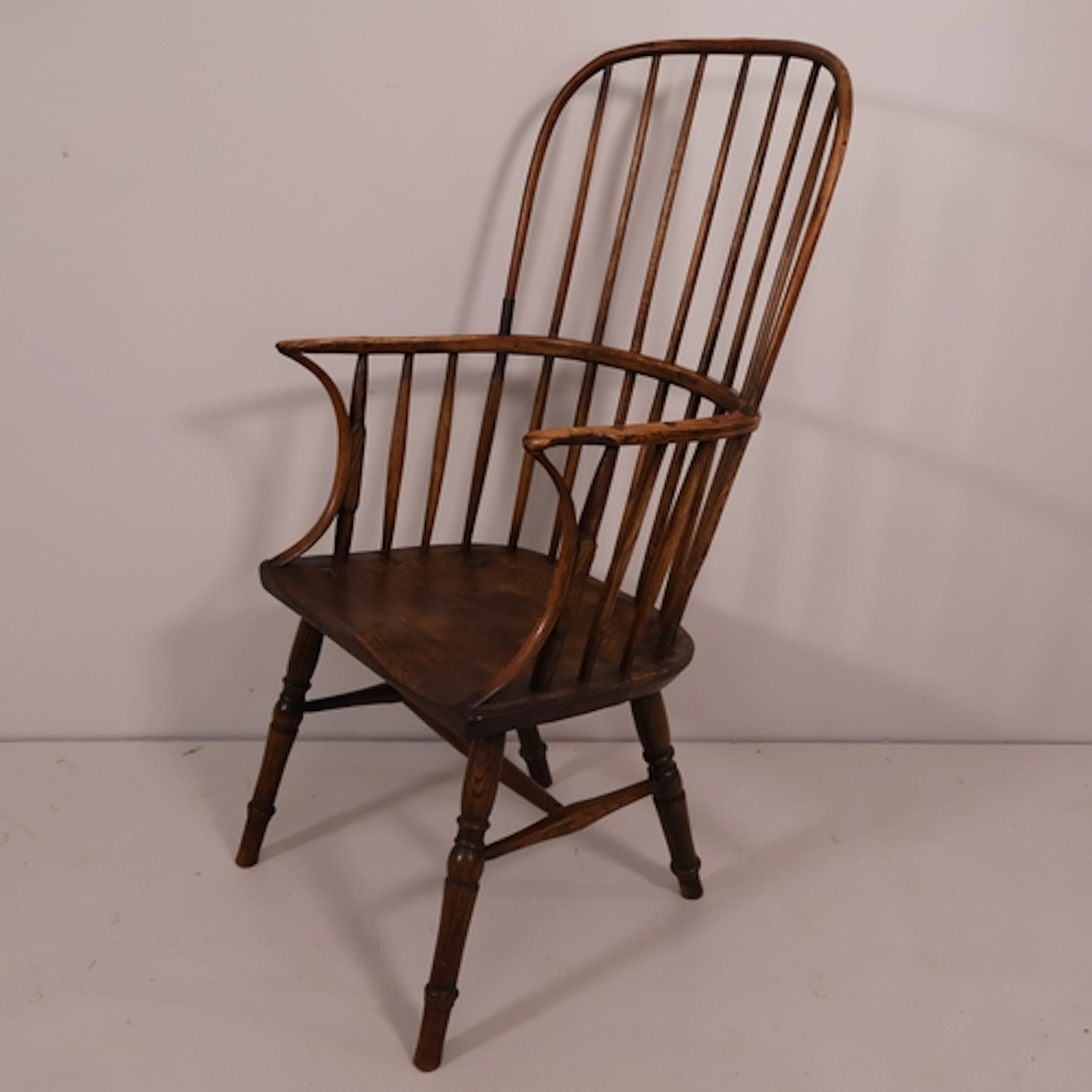 A 19th century Georgian comb-back Windsor arm chair with ash...