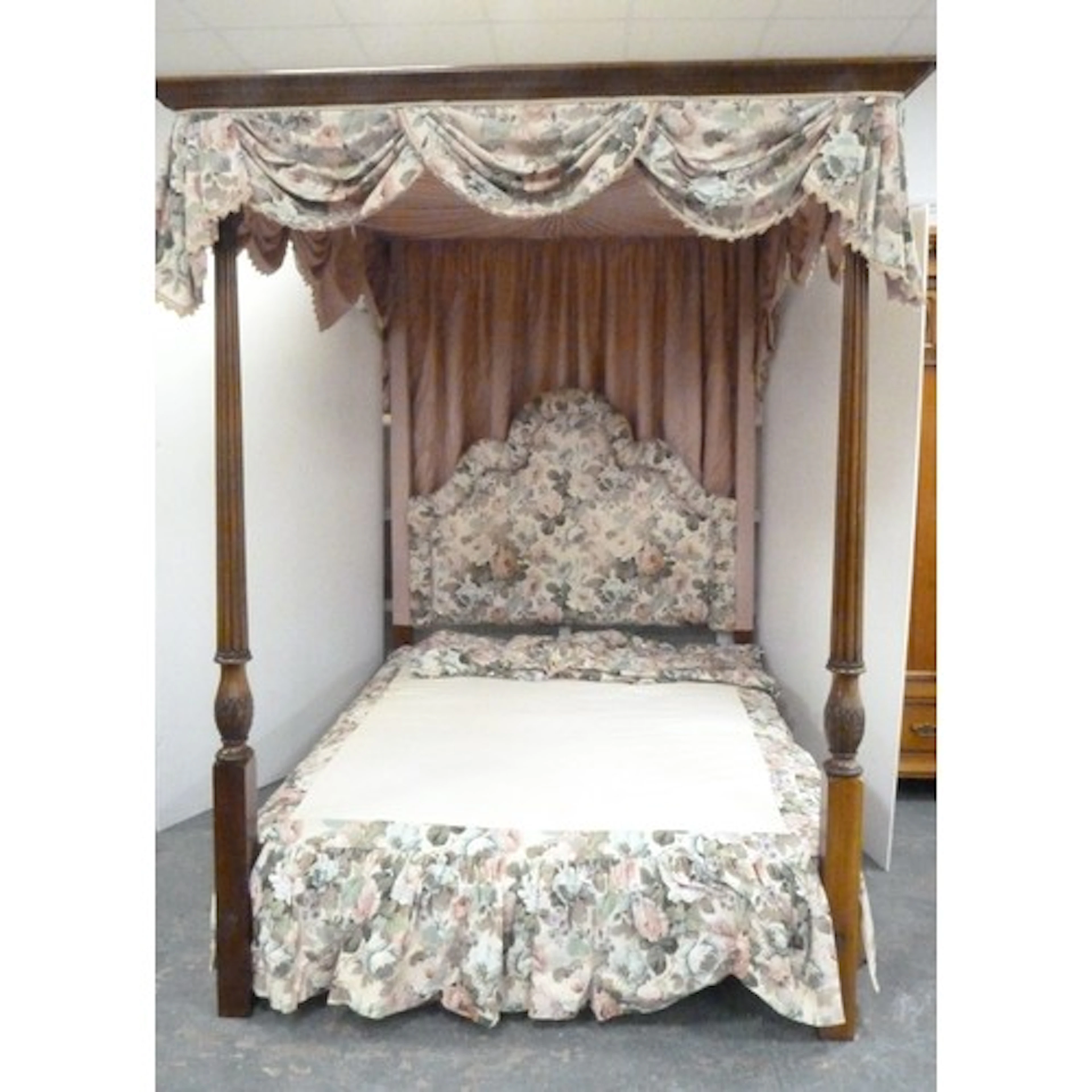 Four poster bed with canopy and floral fabric drapes, side r...