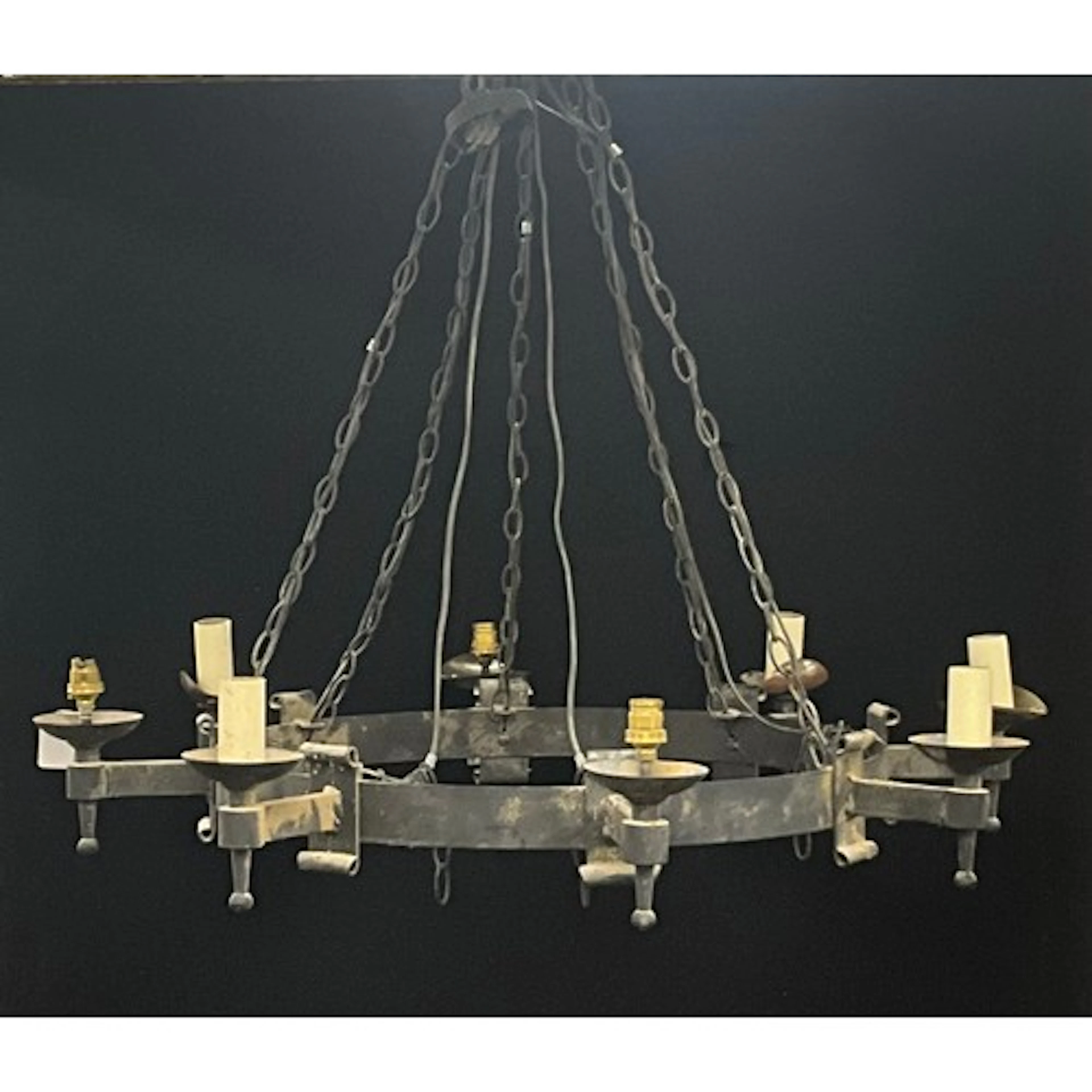 A wrought iron strap work eight light Gothic wheel chandelie...