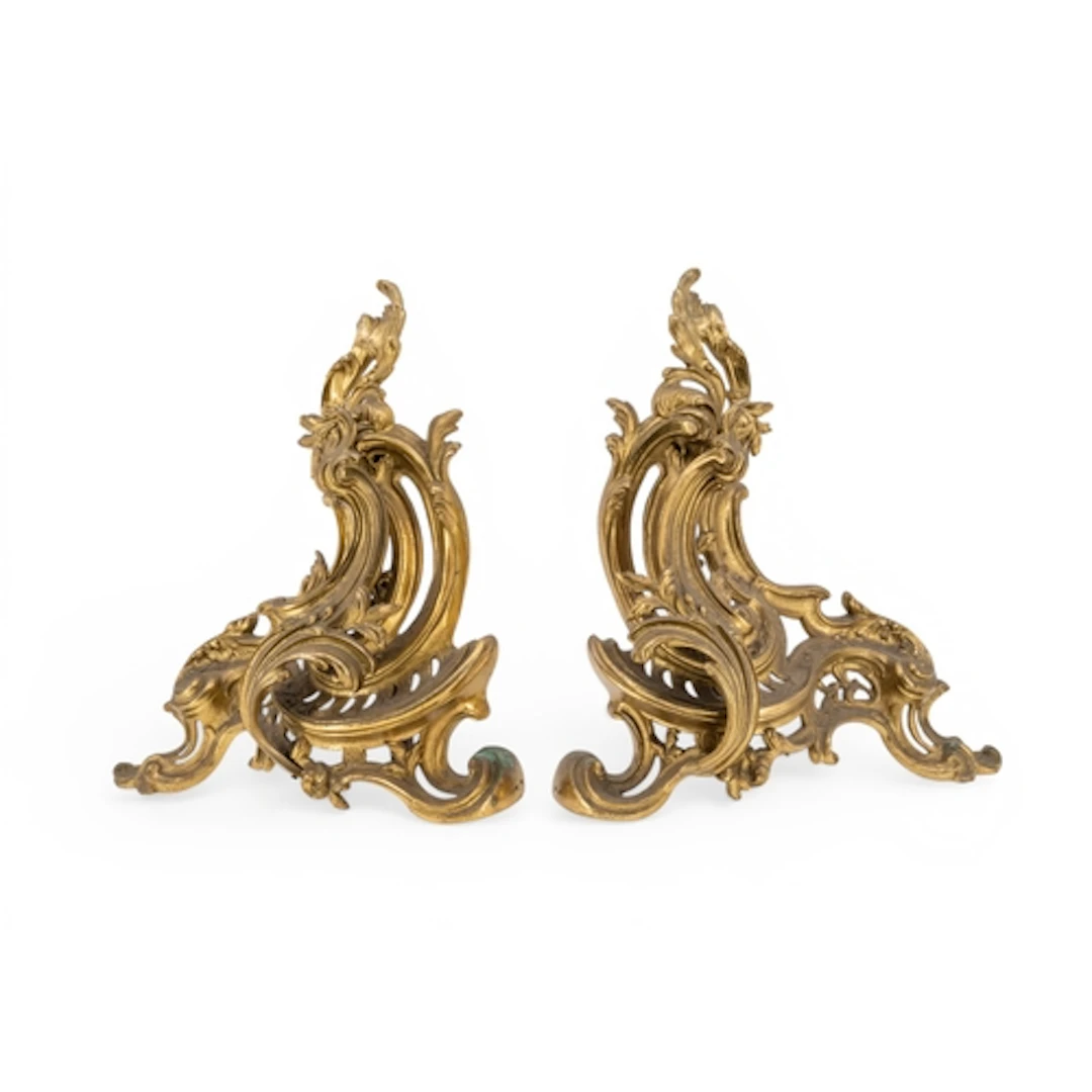 A PAIR OF BRASS ROCOCO STYLE FRENCH CHENET ornately cast wit...