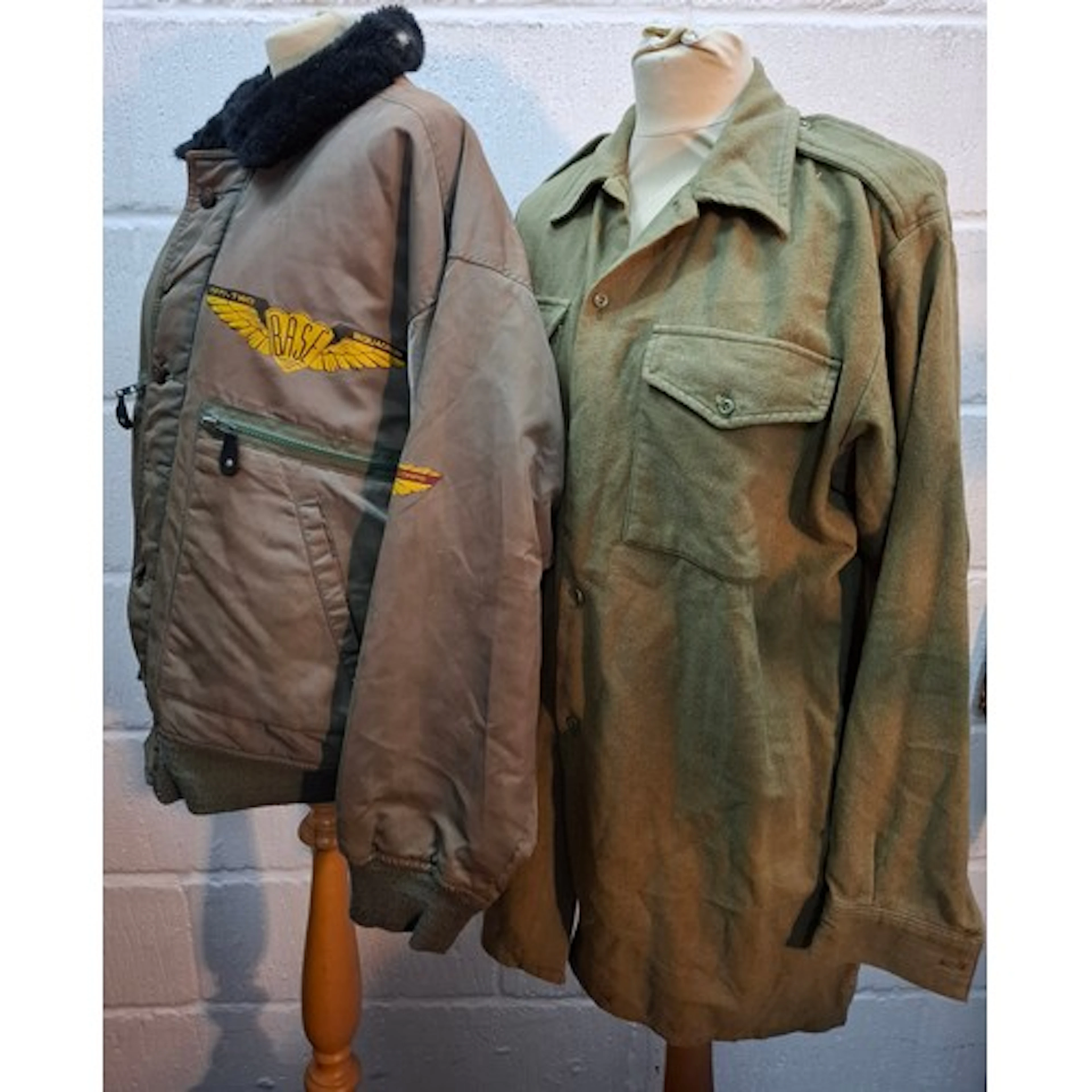 A late 20th Century olive green bomber jacket with a faux bl...