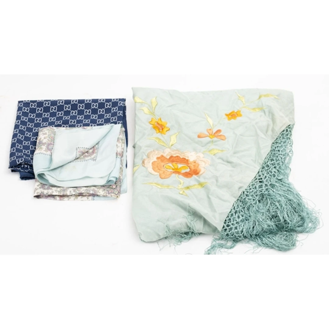 A group of three silk scarves. Comprising a Gucci blue and w...