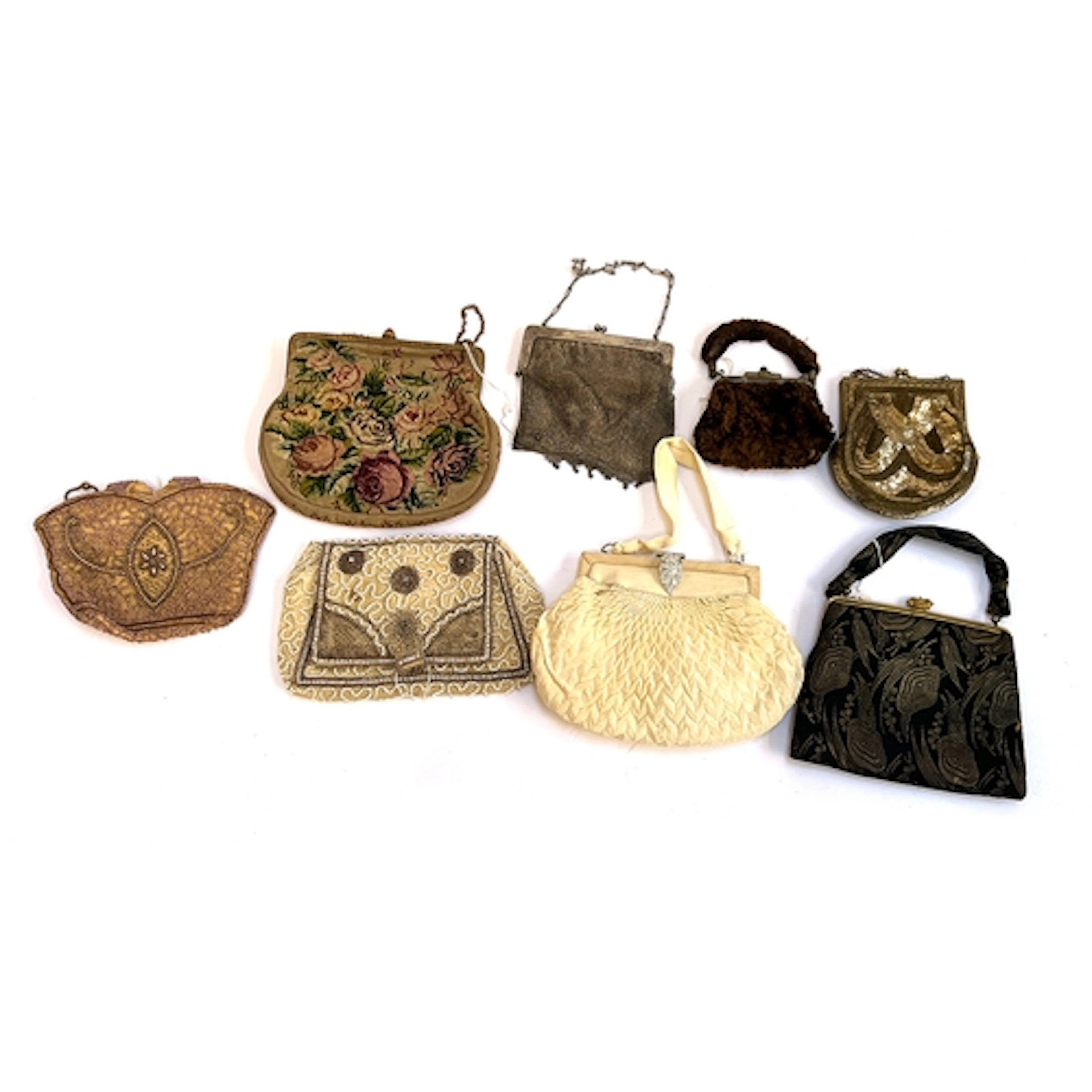 A collection of various clutch purses and bags, evening dres...
