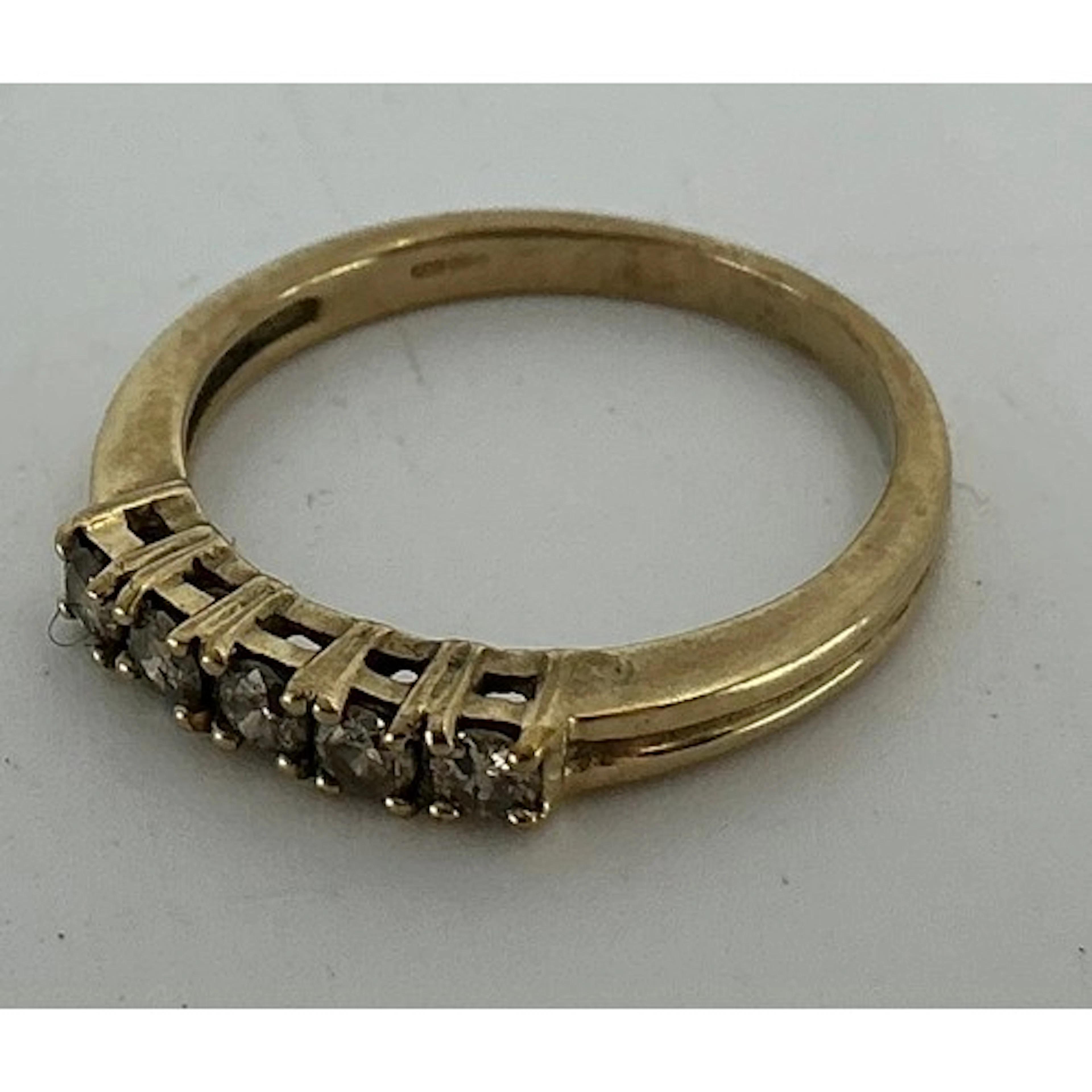 A champagne diamond ring, linear set with five round brillia...