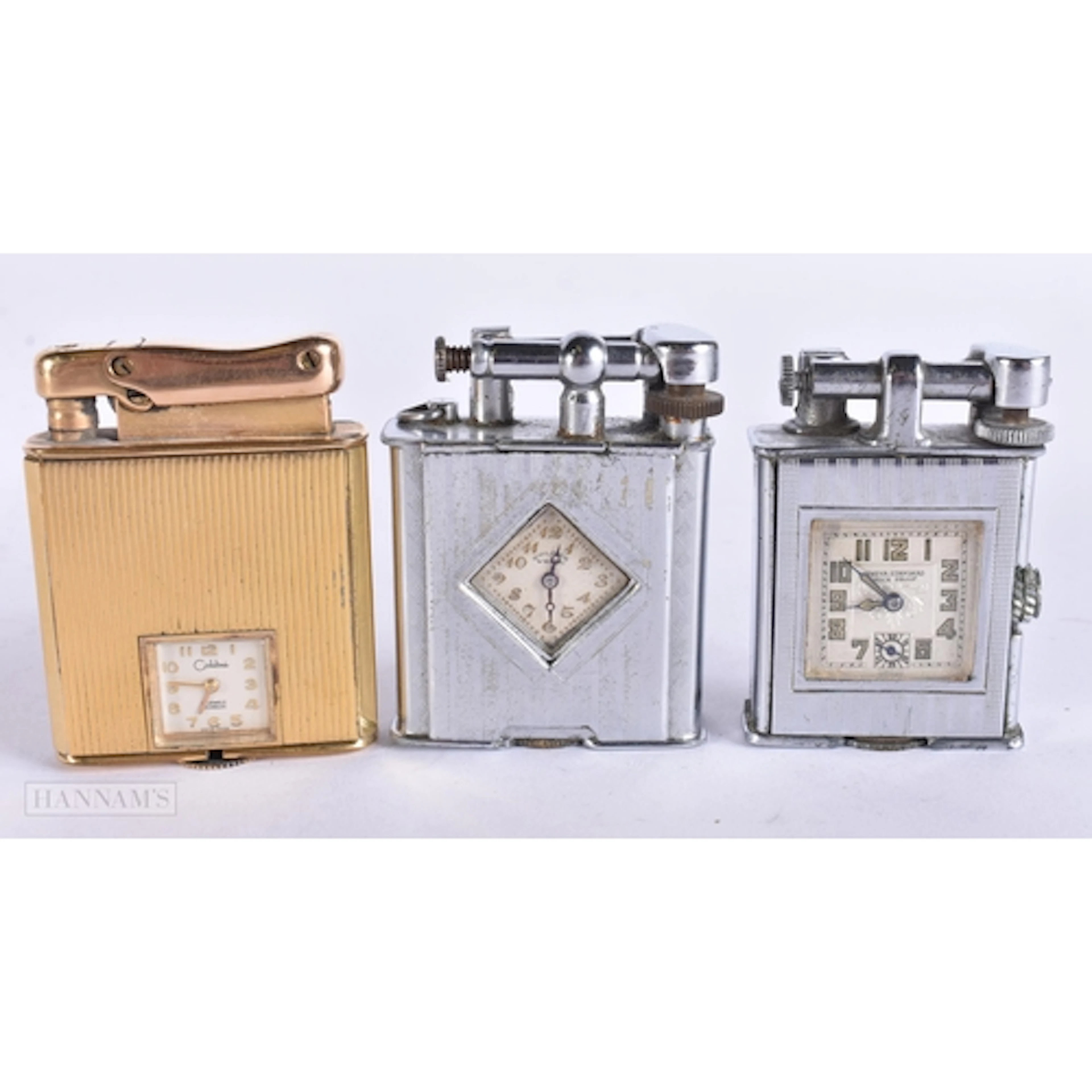 TWO ART DECO AND A 1950S CLOCK WATCH LIGHTER. (3)