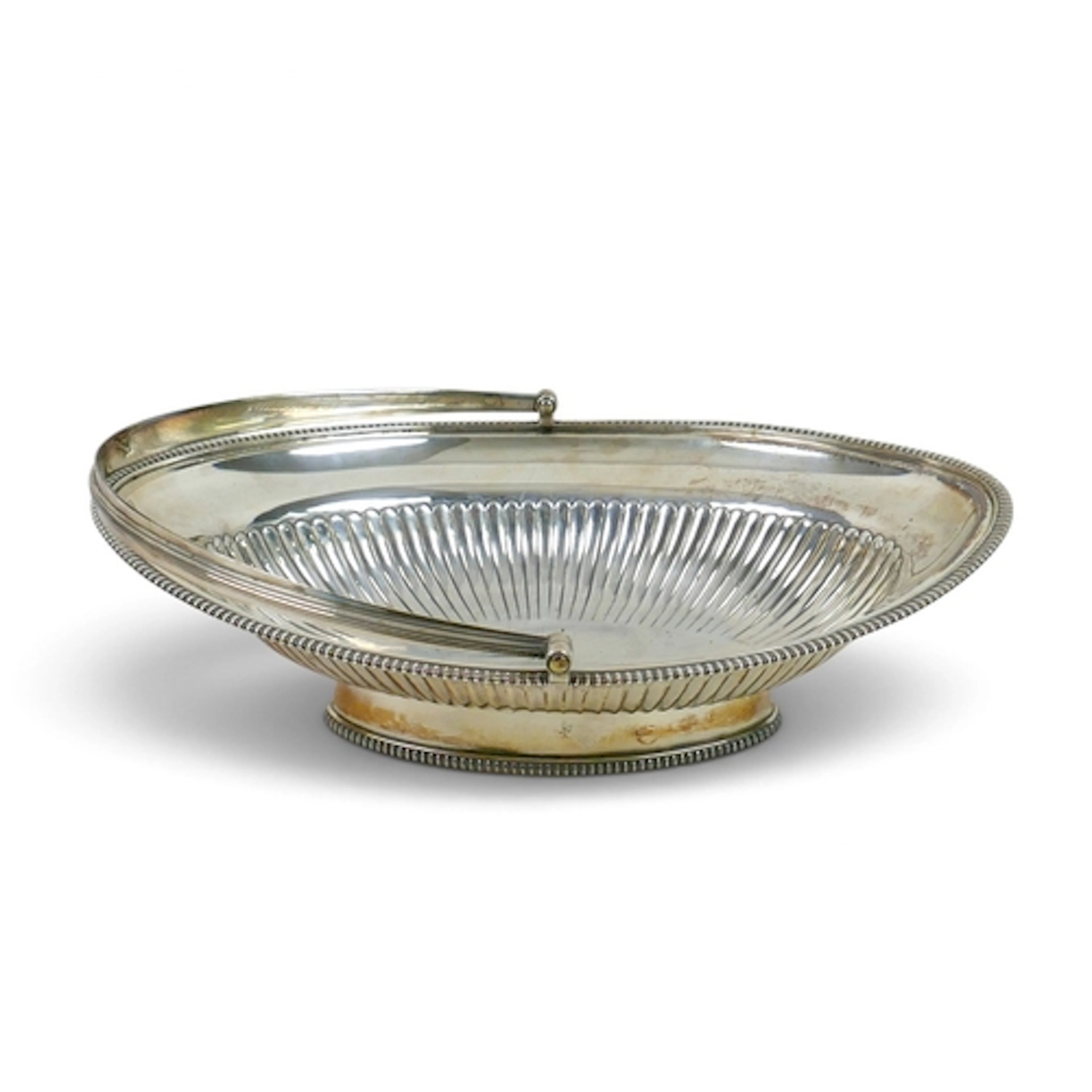 A GEORGE III SILVER FRUIT BASKET. of oval form with swing re...