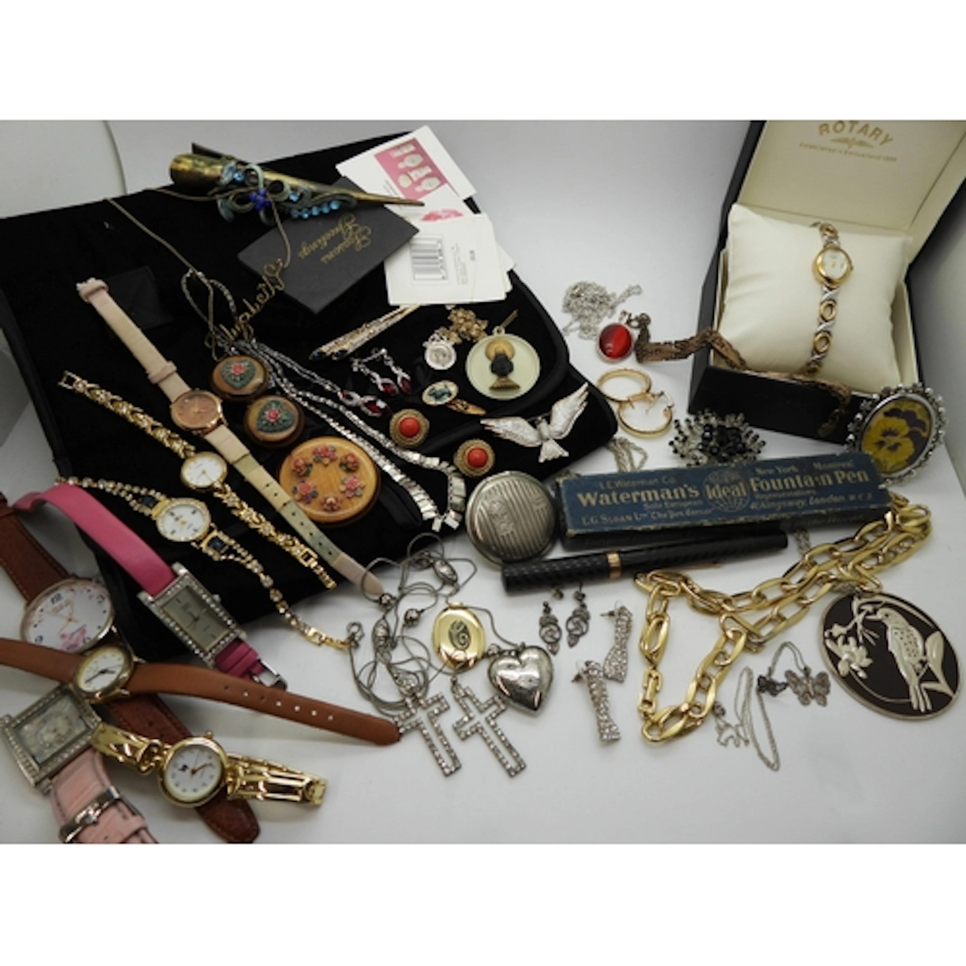 A collection of costume jewellery across a jewellery wrap an...