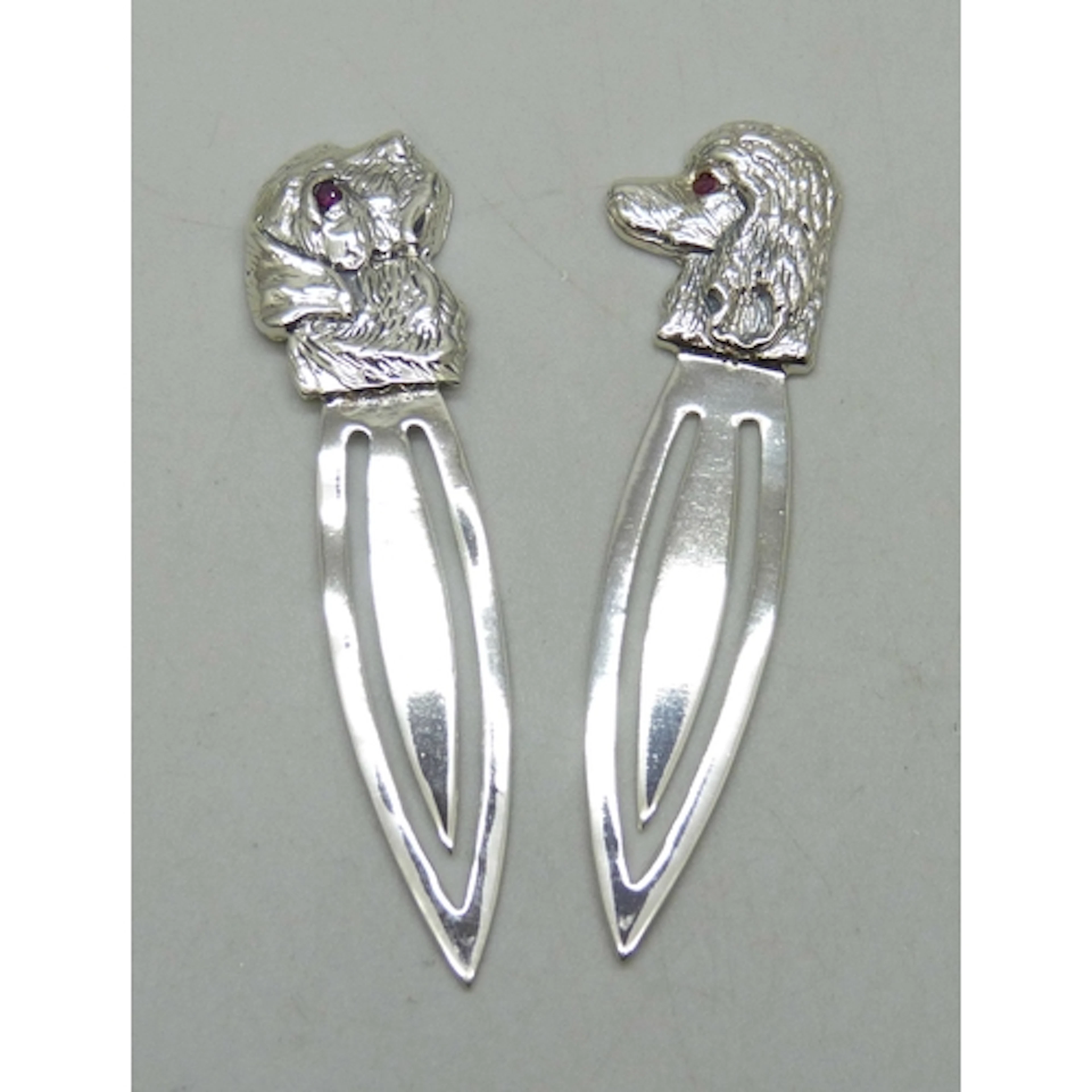 Two silver bookmarks with dog head design set with ruby eyes...