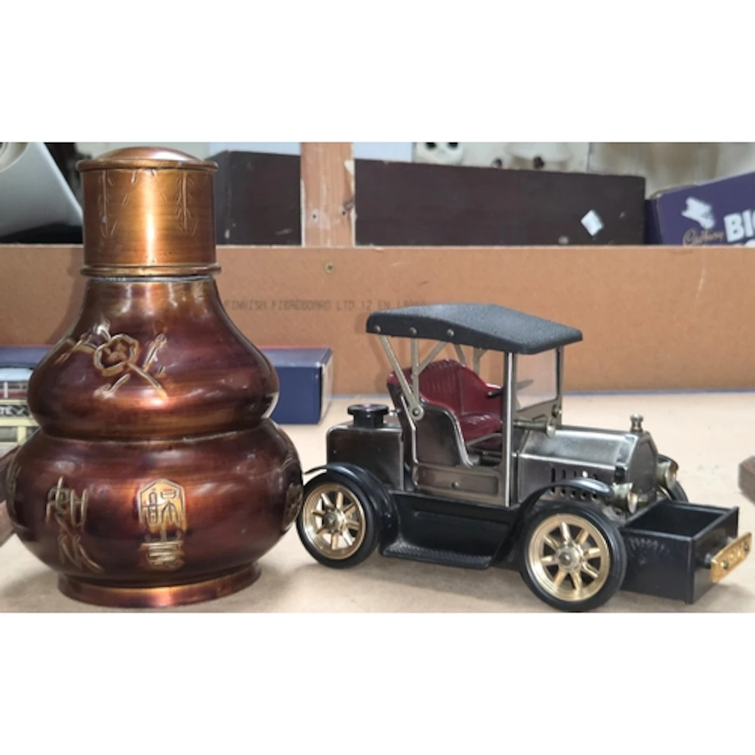 A novelty table lighter in the form of a vintage car; an ori...