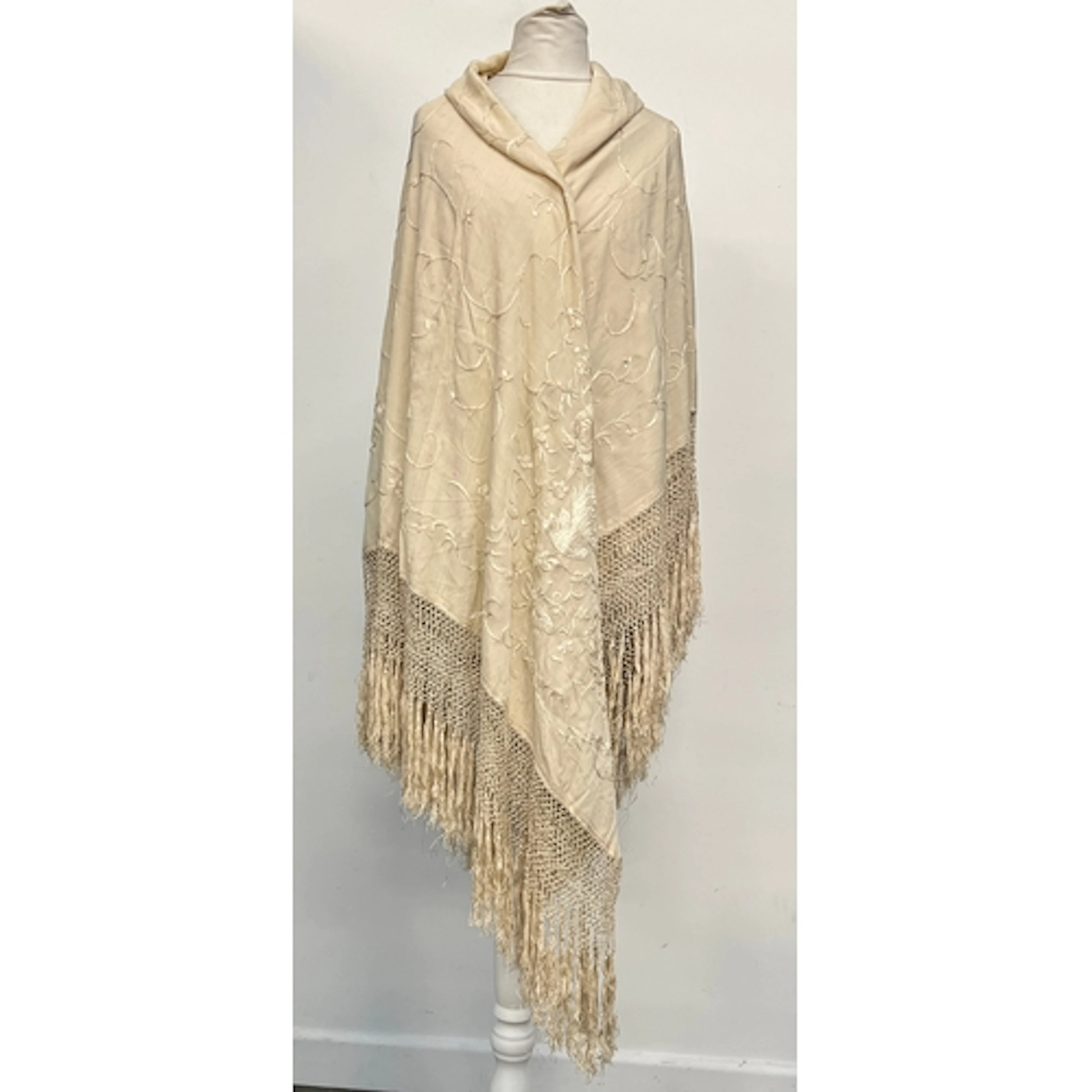 An early 20th century cream silk piano shawl, embroidered wi...