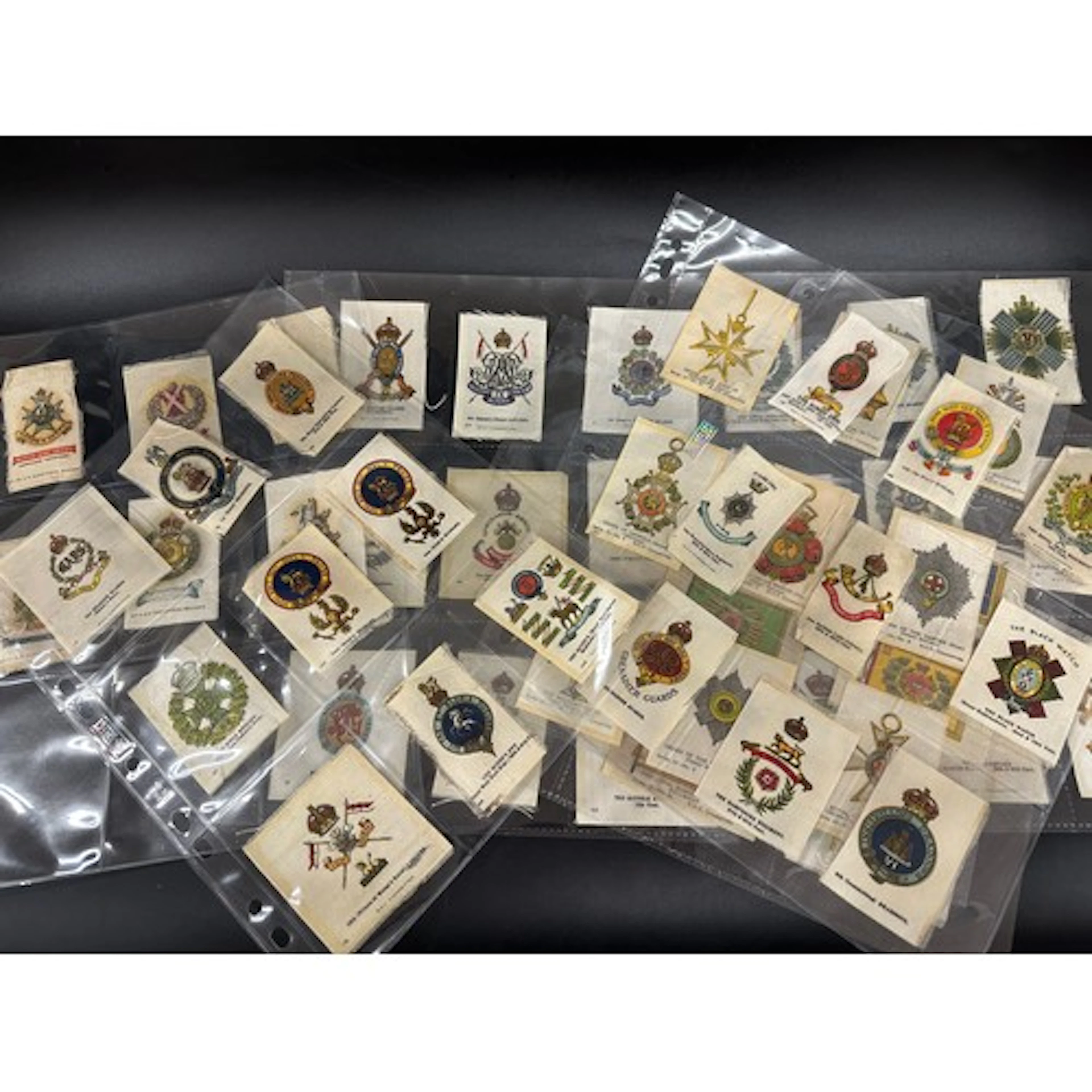 A collection of military cigarette card silks