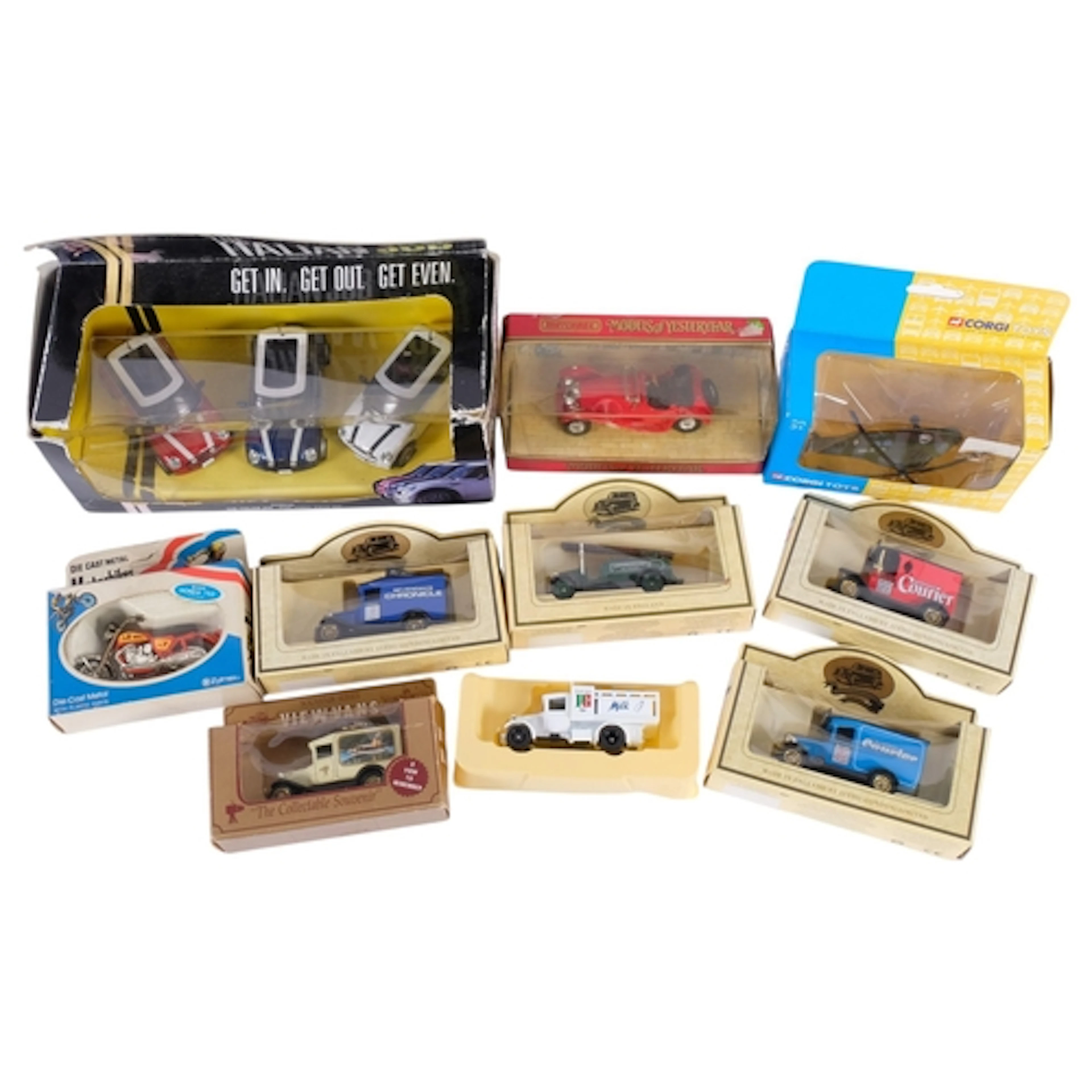 A small collection of boxed diecast vehicles, including a Ho...