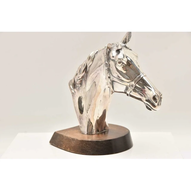 A MOUNTED FILLED SILVER HORSE HEAD, fitted on a wooden base,...