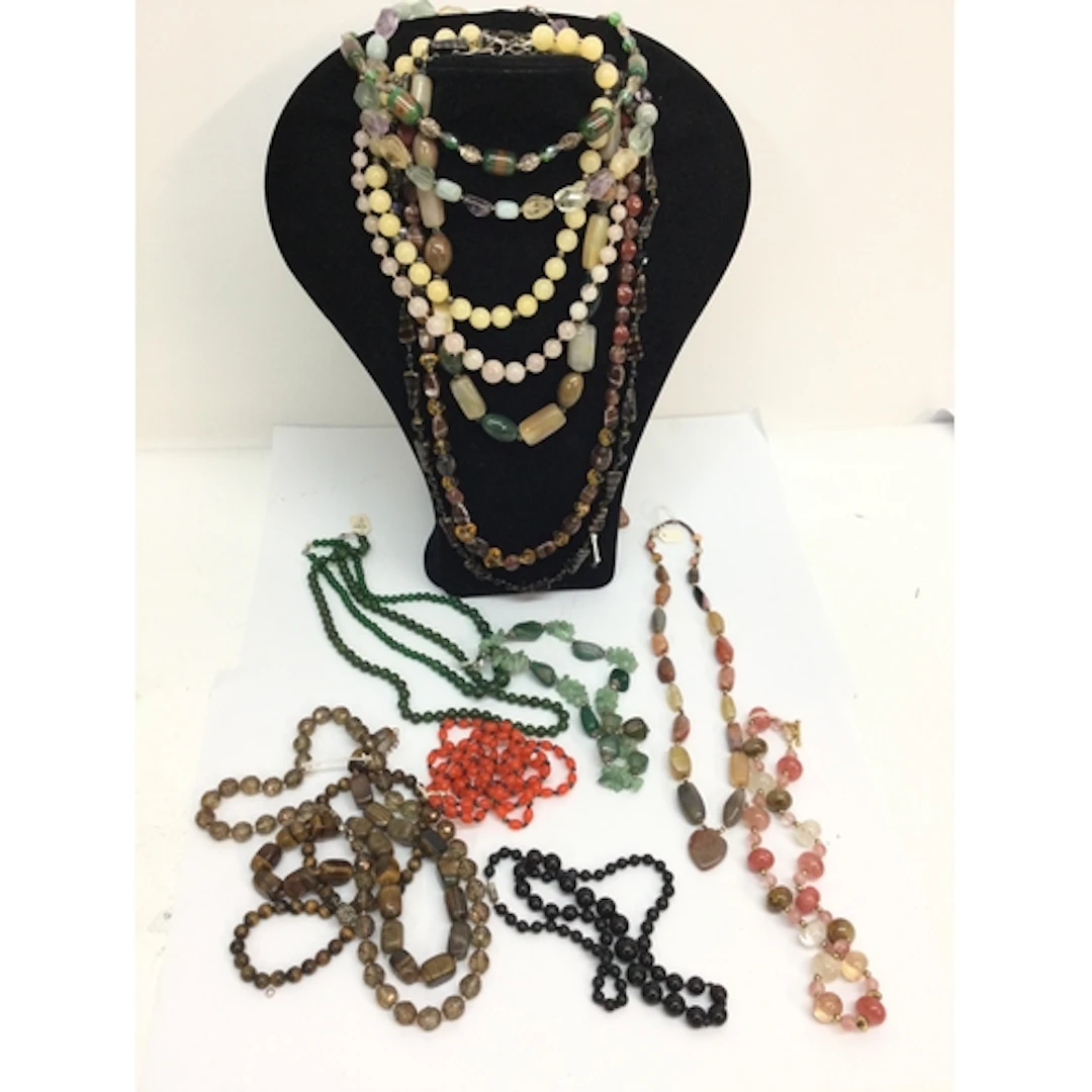 A collection of polished hardstone bead necklaces including ...