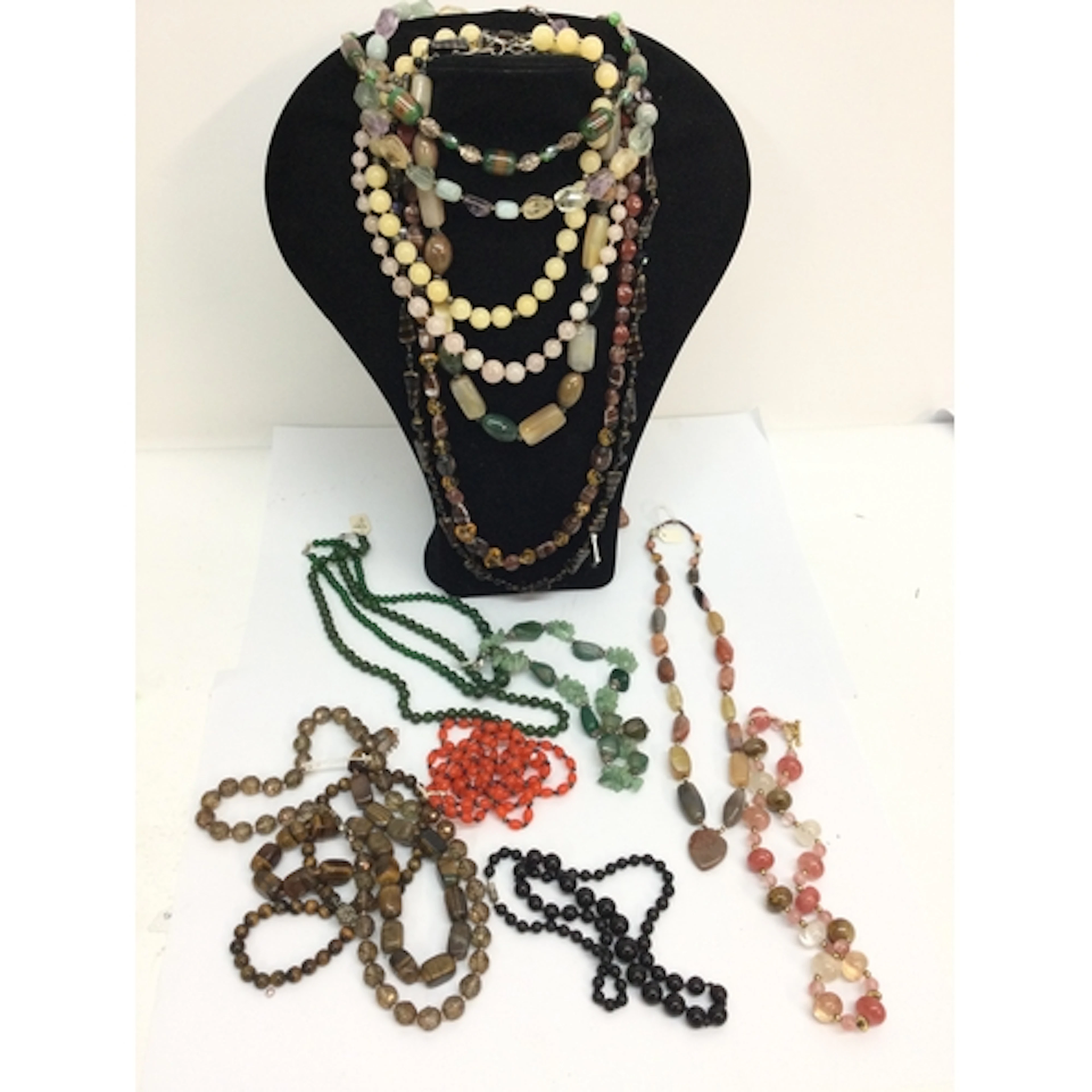 A collection of polished hardstone bead necklaces including ...