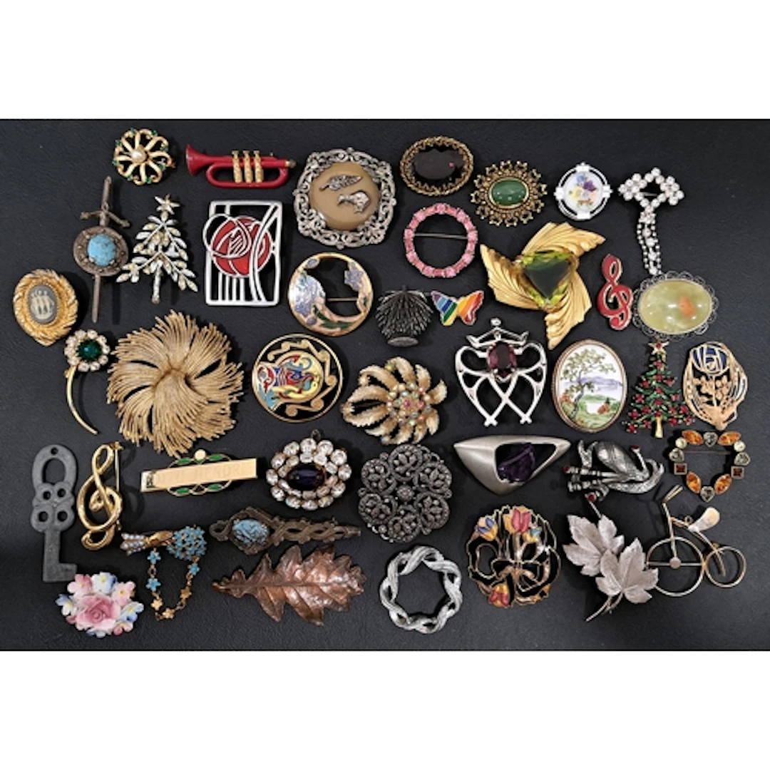 FORTY-TWO VINTAGE BROOCHES including stone, paste, and clois...