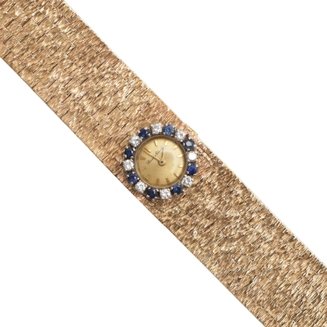 A LADY'S SAPPHIRE, DIAMOND AND 9CT GOLD WRISTWATCHBY BUECHE ...