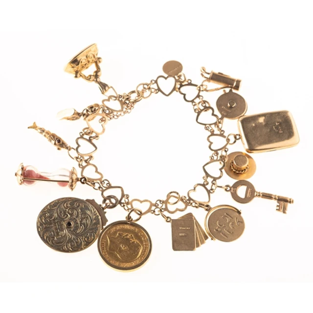 A heart bracelet with attached charms, an open heart link br...