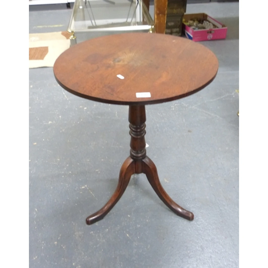 Antique mahogany pedestal table on tripod supports.