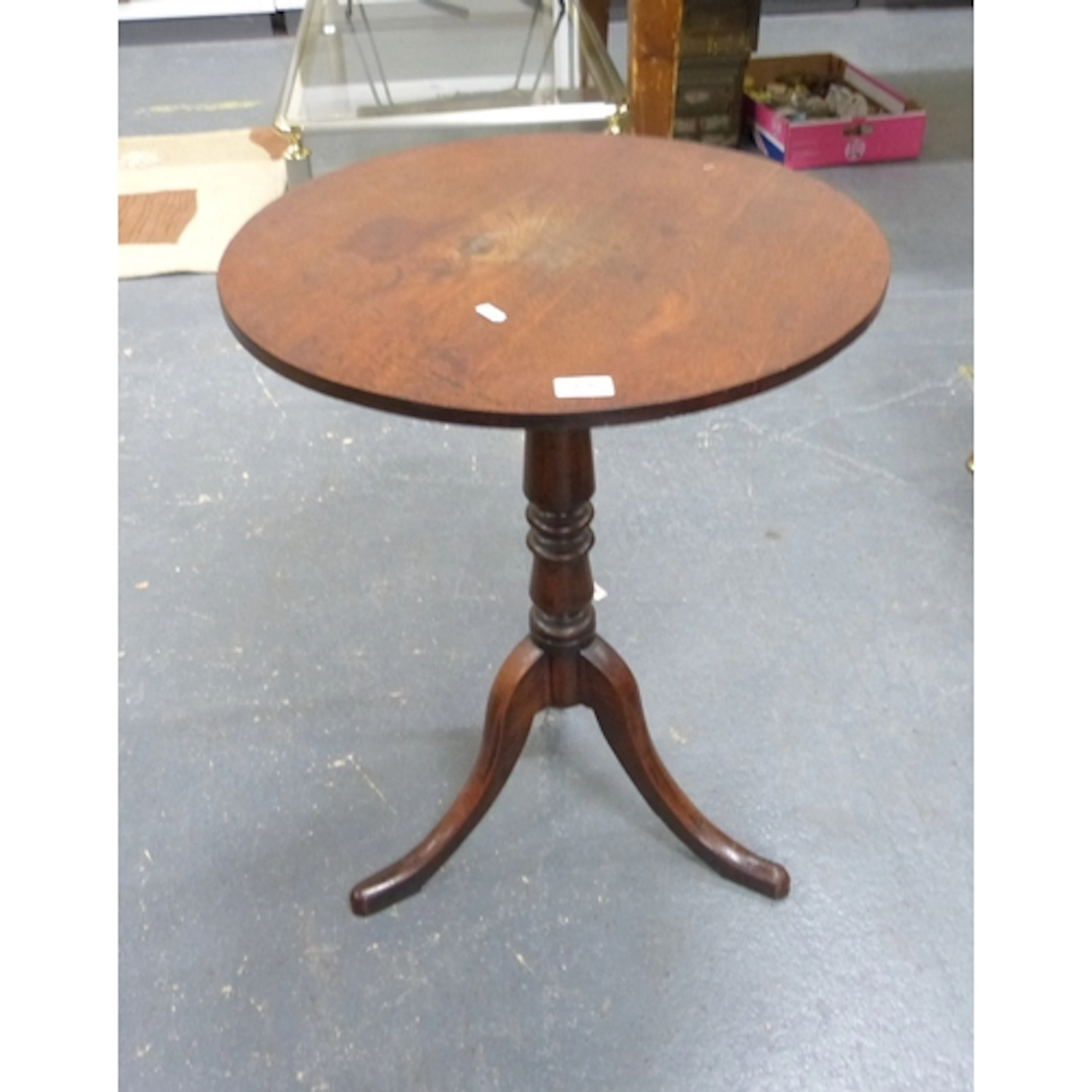 Antique mahogany pedestal table on tripod supports.