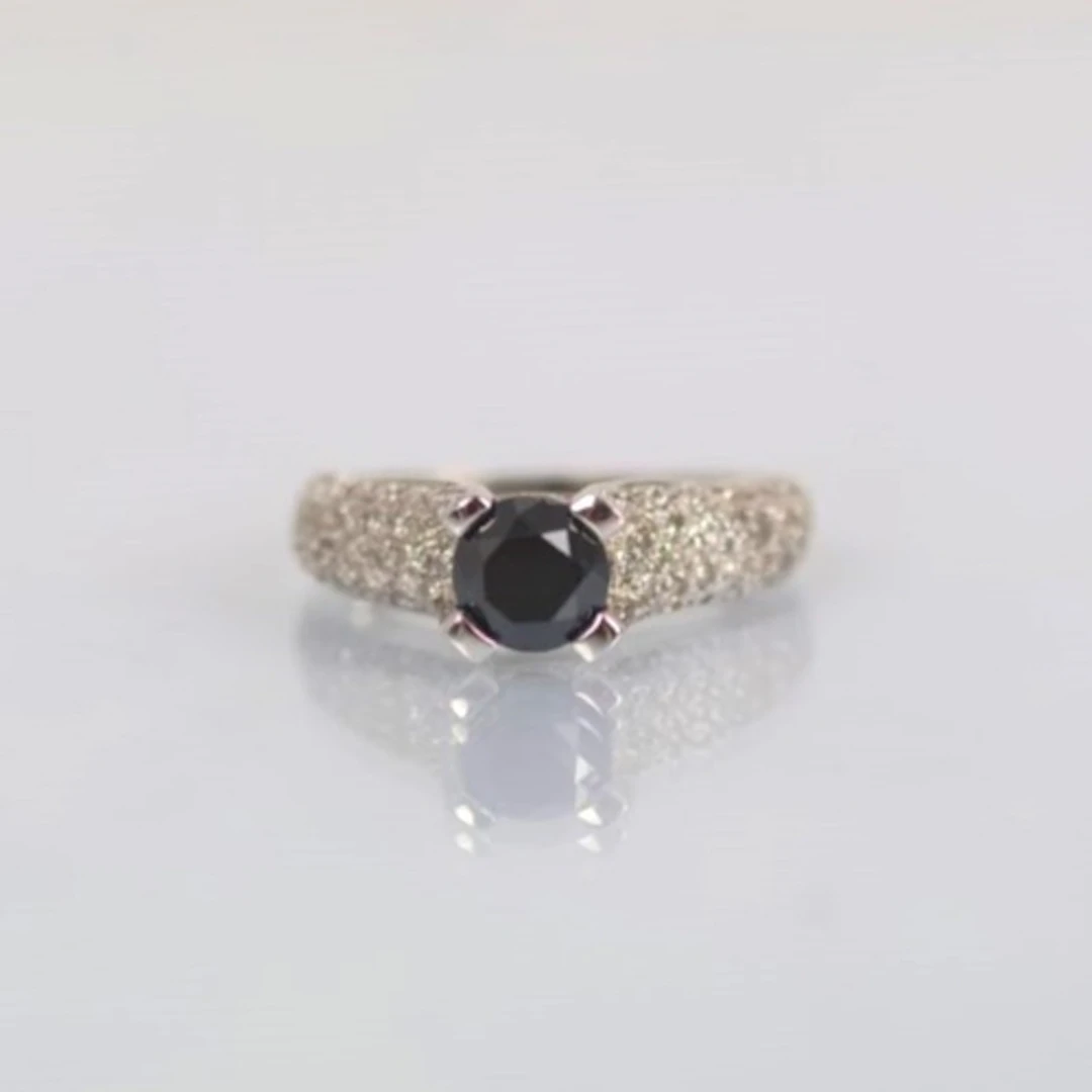 A contemporary 9ct white gold dress ring, the black diamond ...