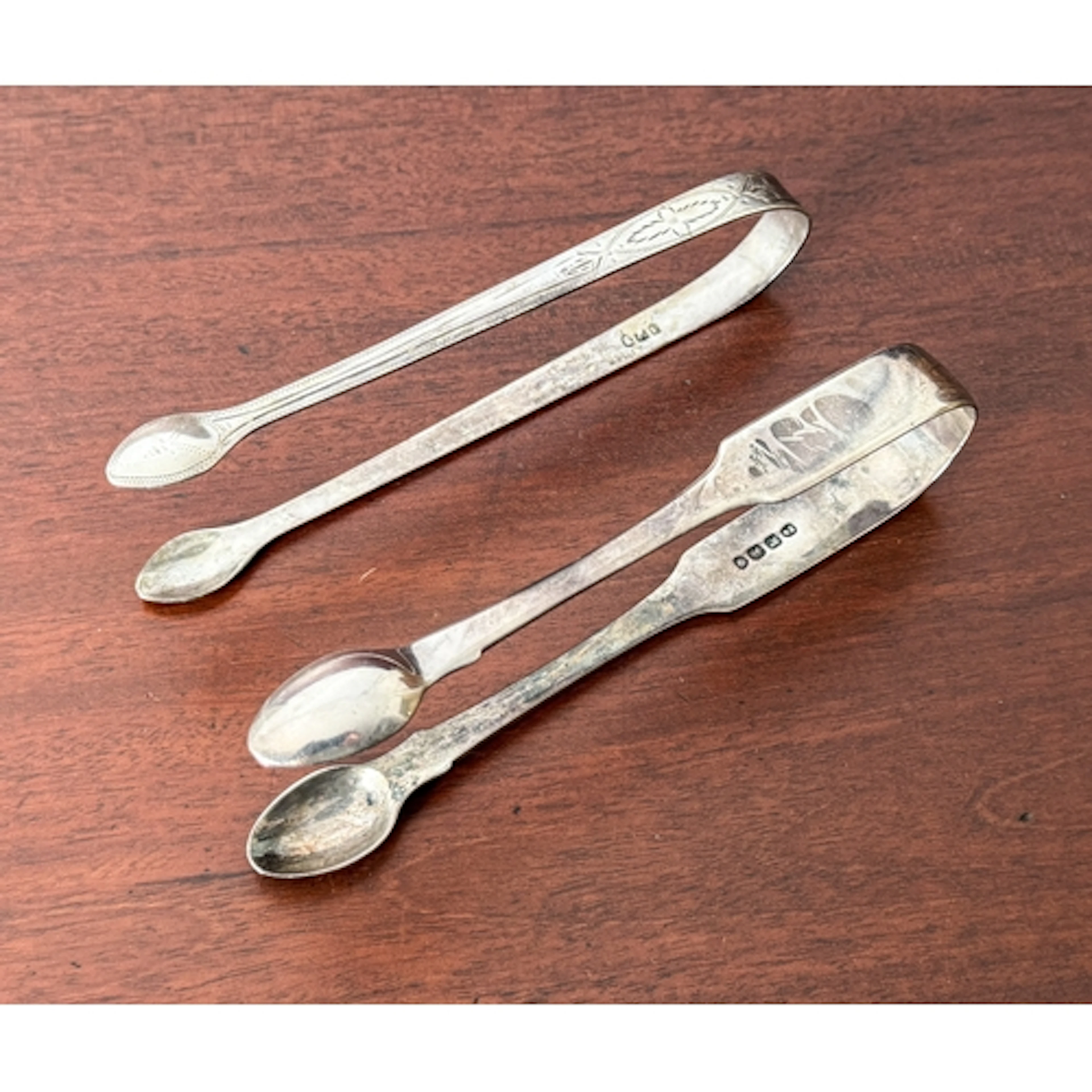 Two silver sugar tongs - to include a George III pair of sug...