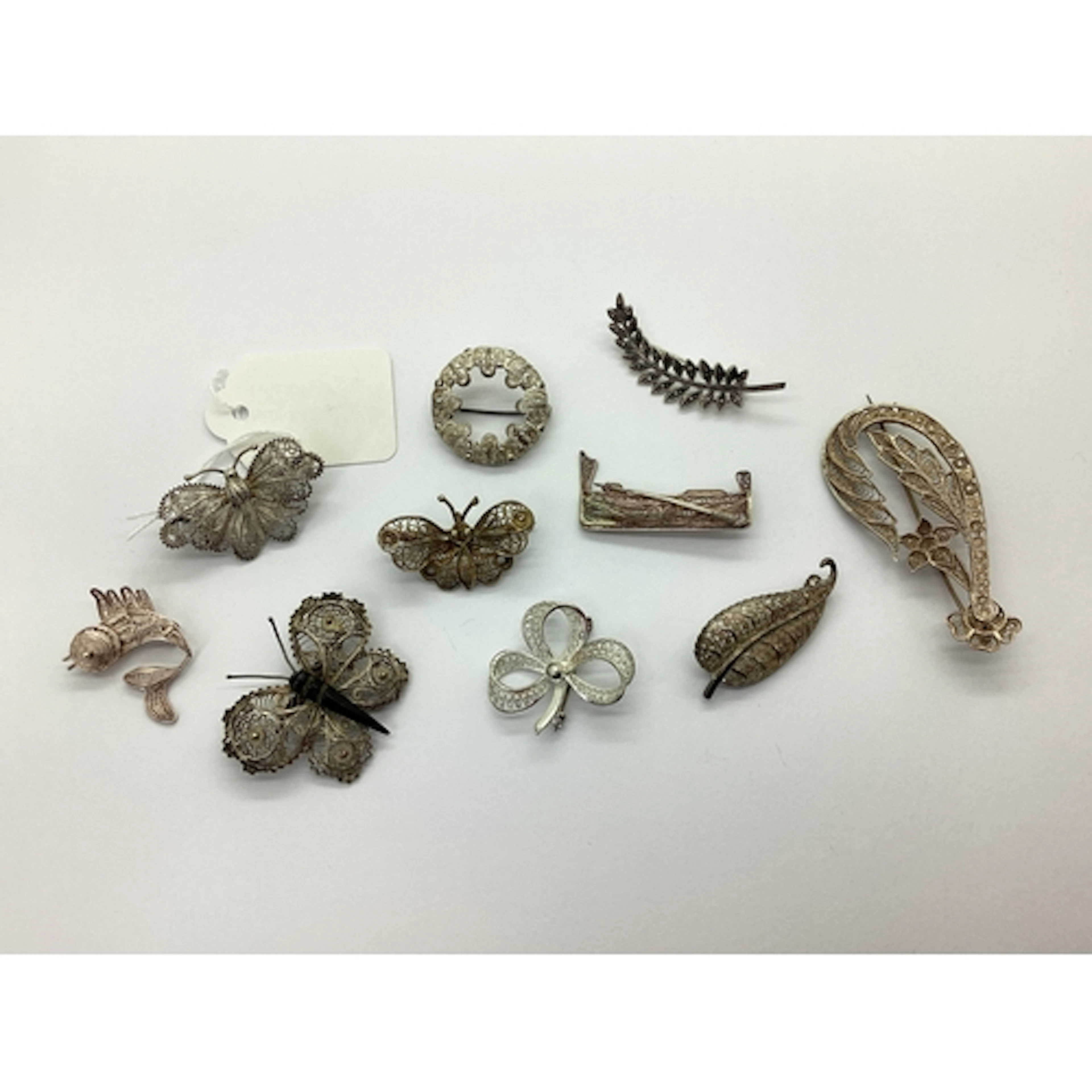 A Selection of Decorative Filigree Brooches, including butte...