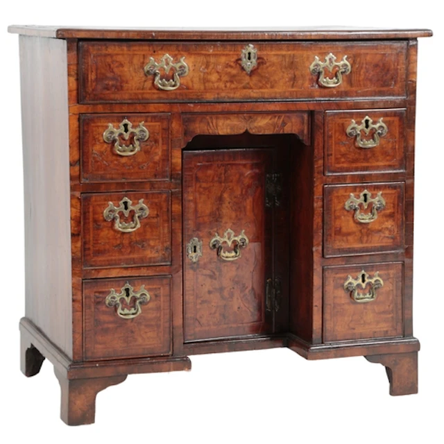 A George II figured walnut and featherbanded kneehole desk, ...