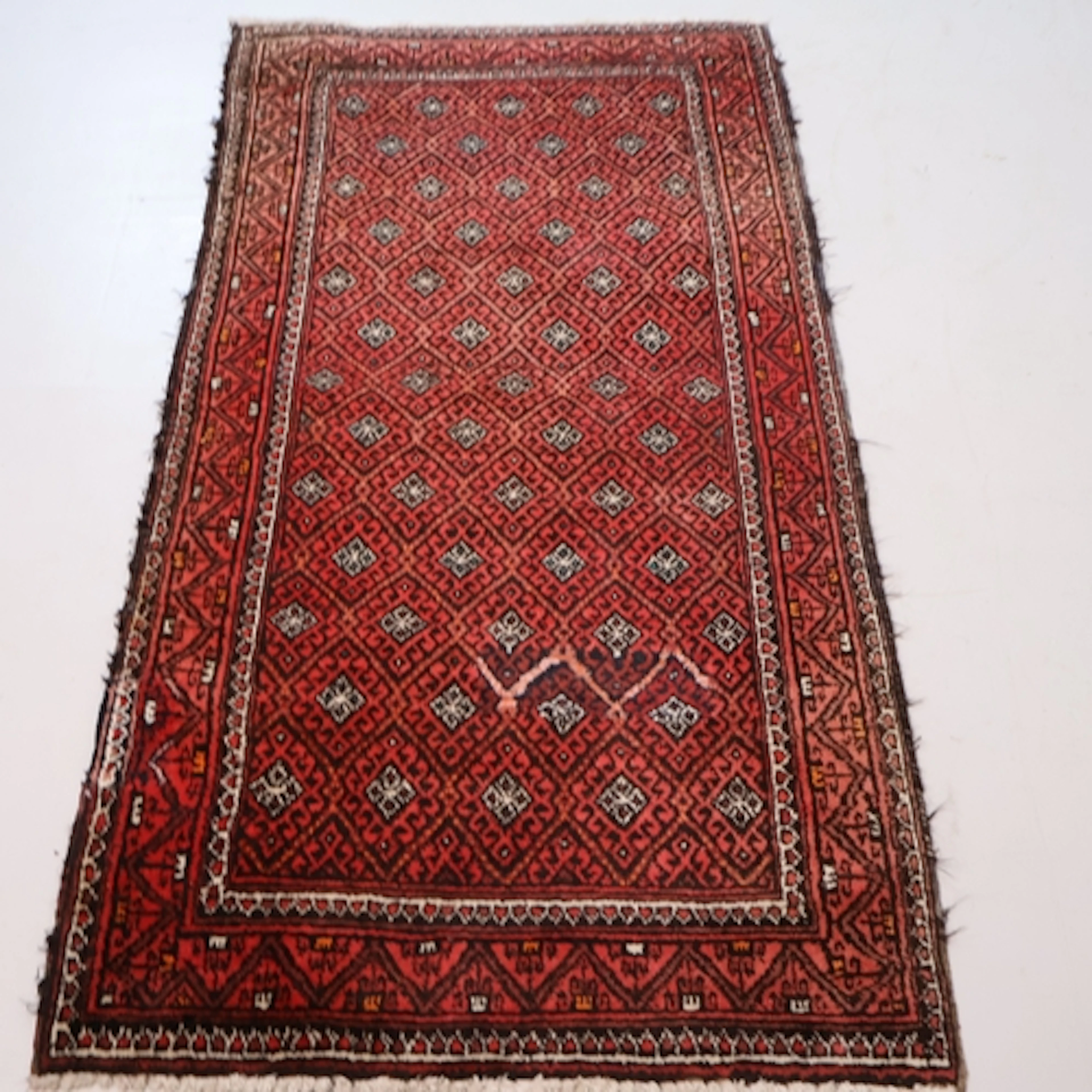 A red ground Afghan rug, L194cm, W102cm.