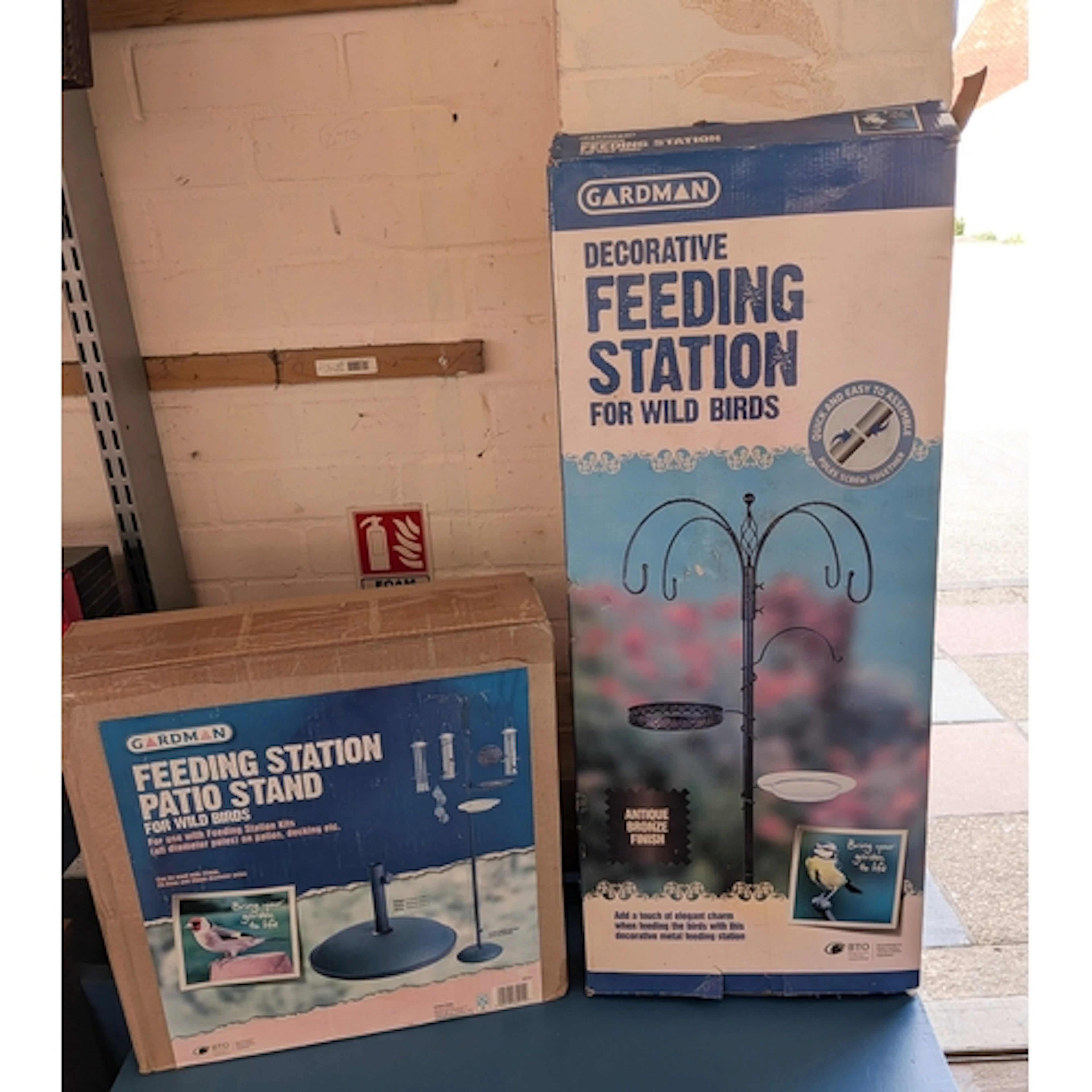 A bird feeding station with a stand - both boxed