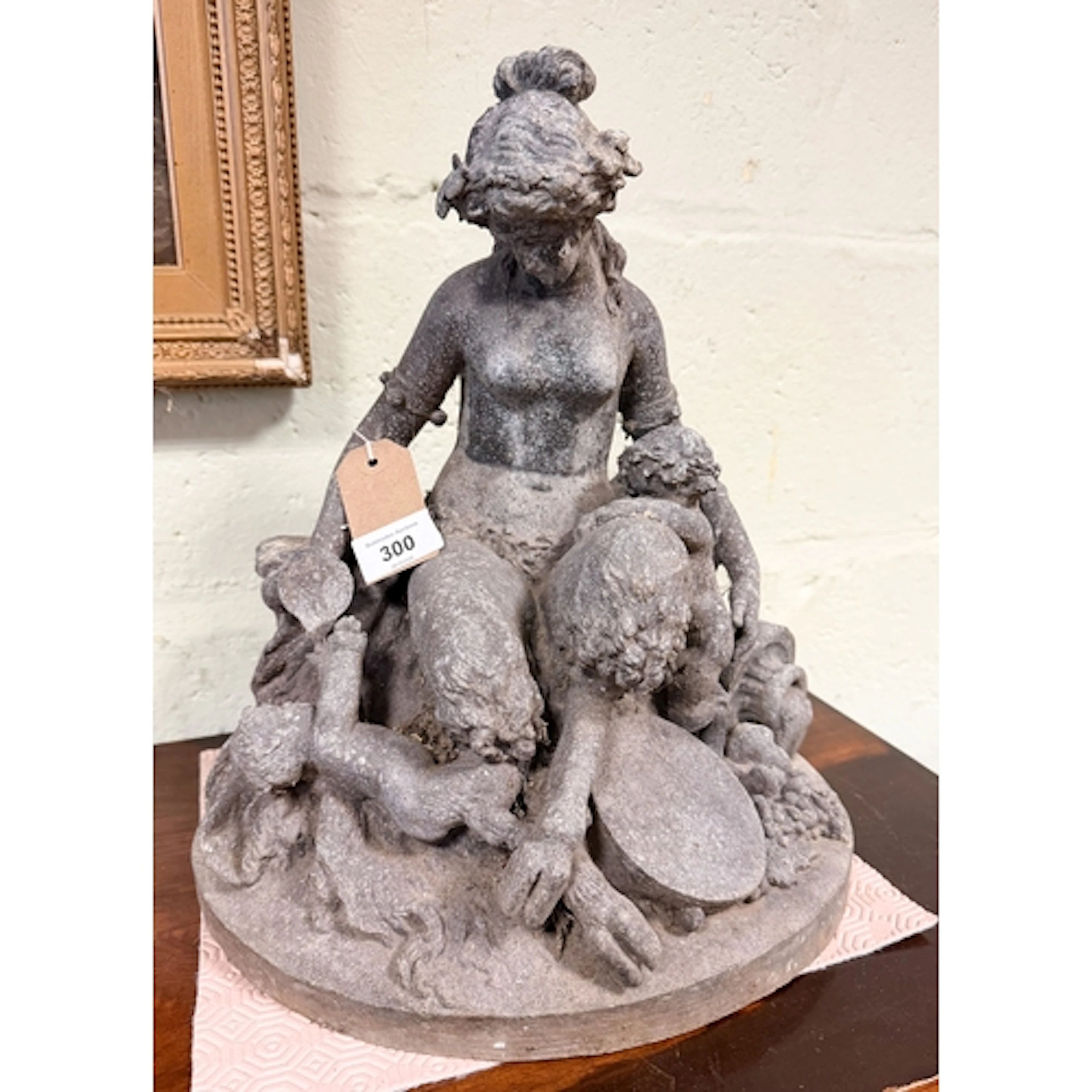 A Victorian lead figured group of faun with puttis, 15" tall